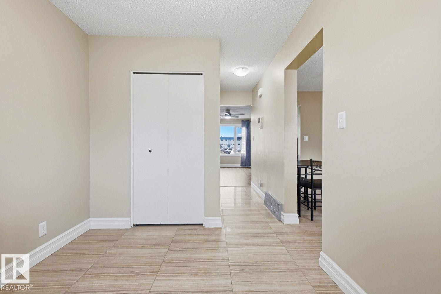 Tiled flooring throughout, neutral wall tones, and white trim - 11317 22 Avenue Nw, Edmonton, AB