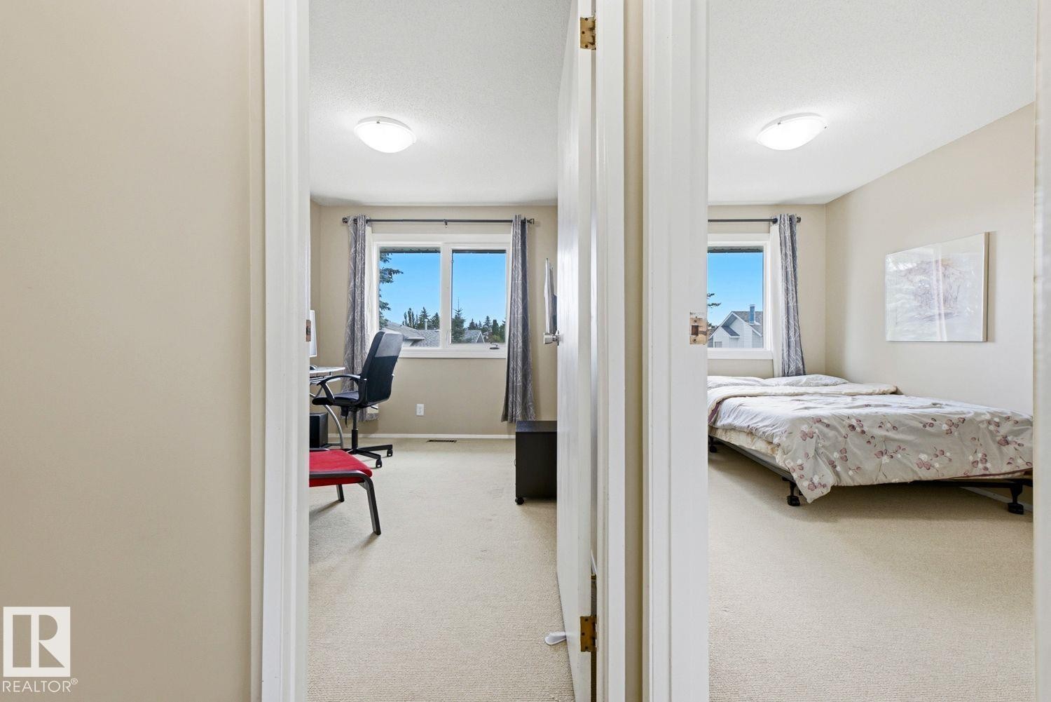 Rooms featuring neutral wall tones, carpeted flooring, and windows with window treatments - 11317 22 Avenue Nw, Edmonton, AB