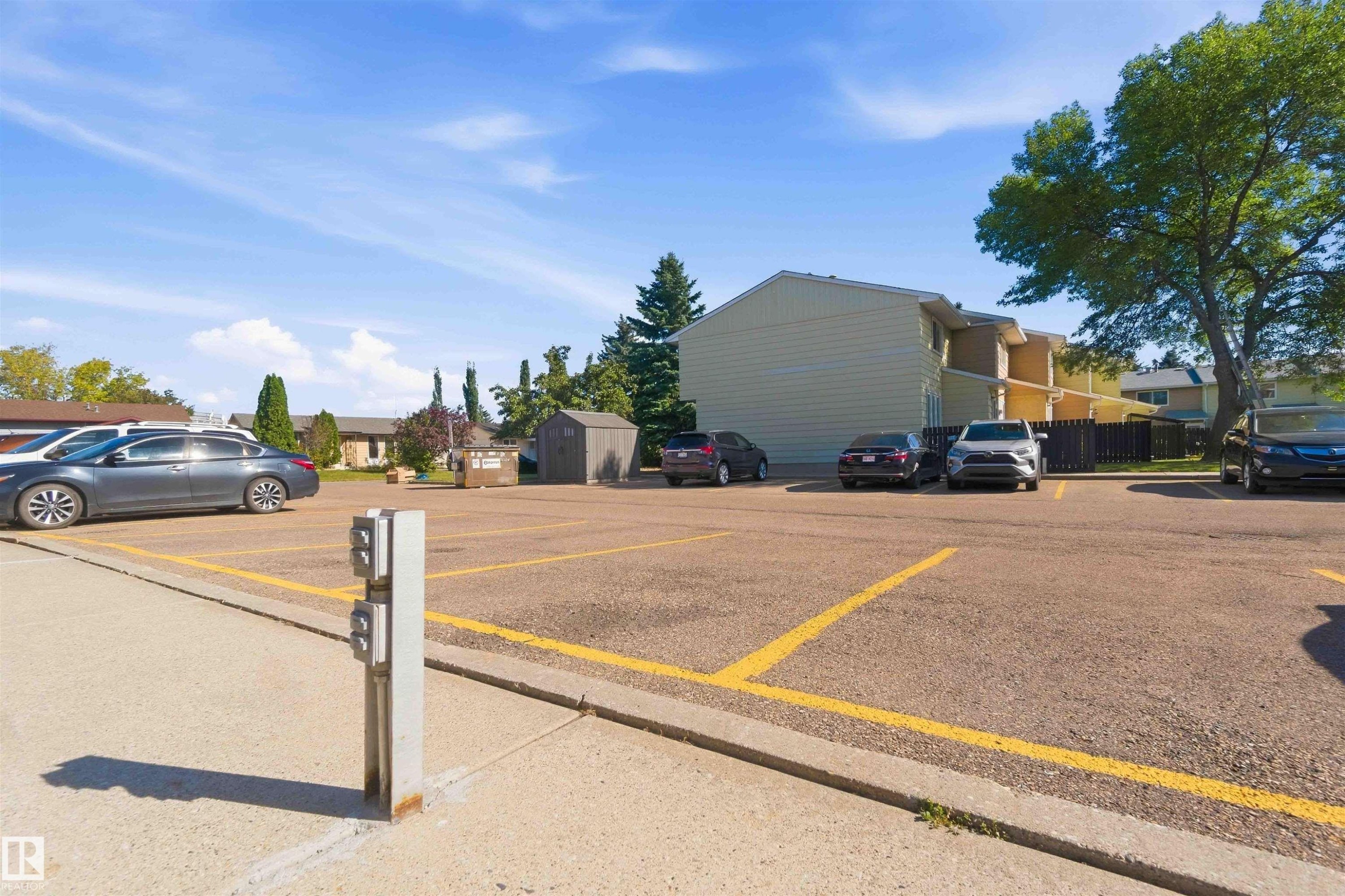 Paved parking lot with designated spaces and an exterior power pedestal - 17351 85 Avenue Nw, Edmonton, AB