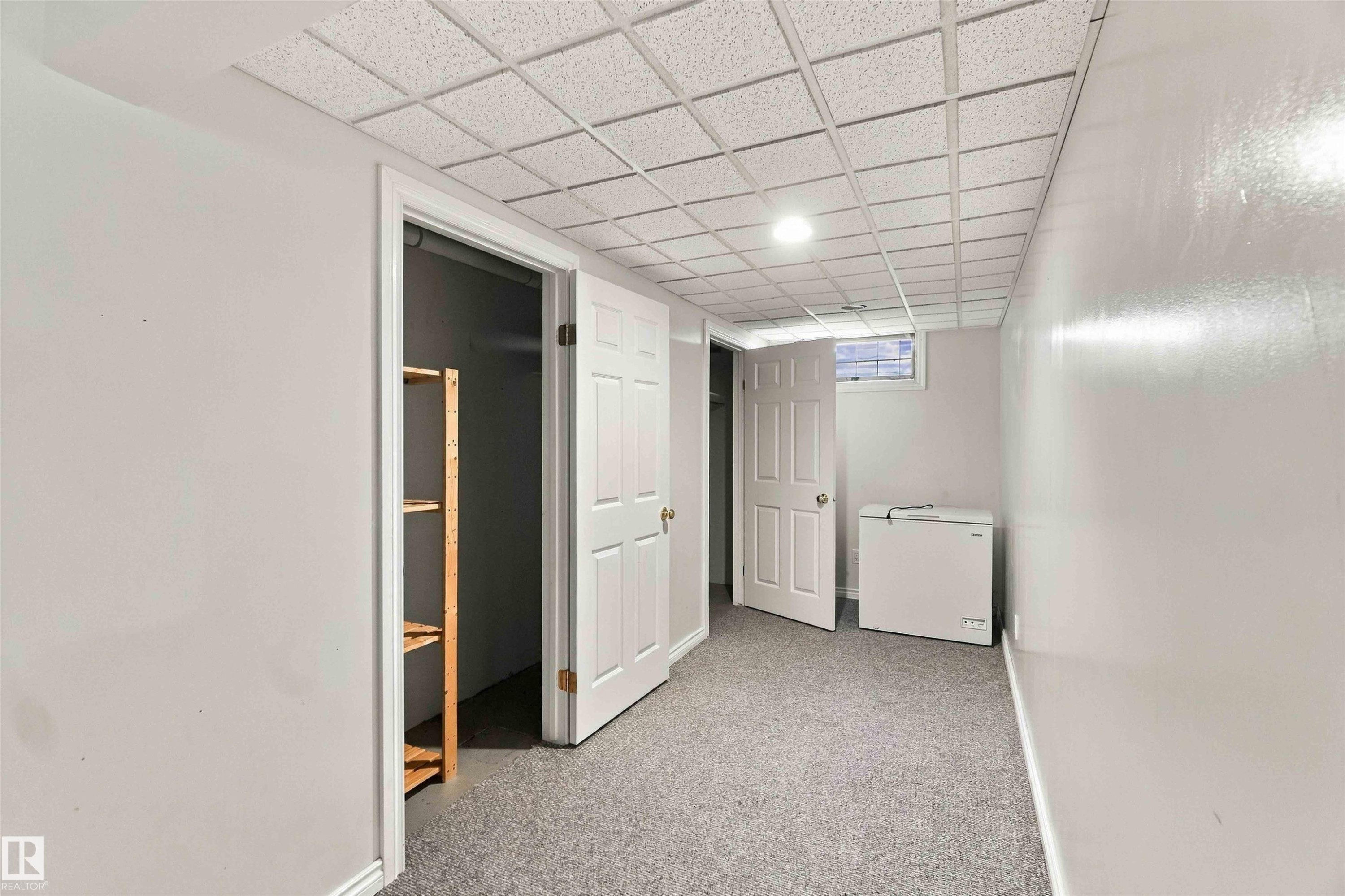 Recessed ceiling lighting, drop ceiling, window, built-in shelving, carpet flooring - 17351 85 Avenue Nw, Edmonton, AB