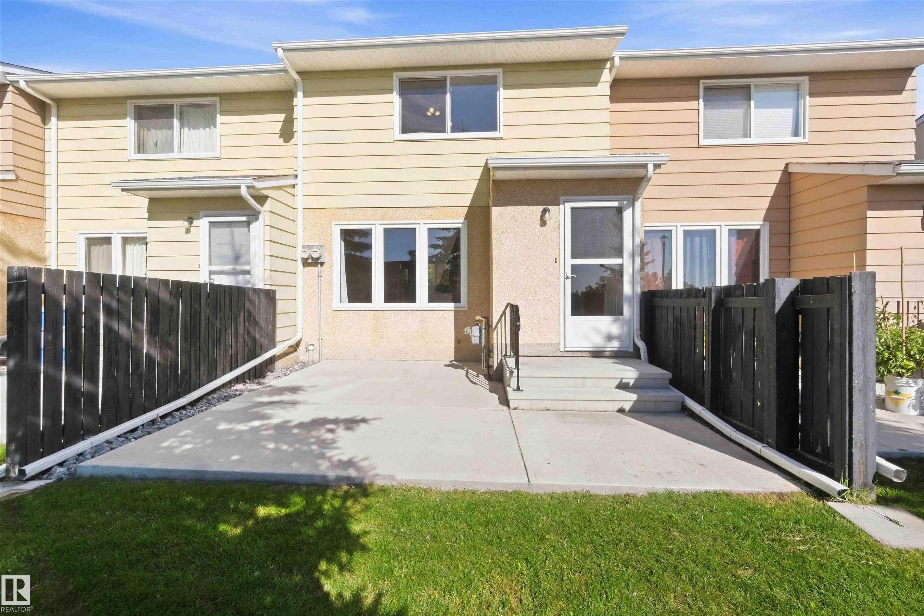 Paved patio with dark wood privacy fencing - 17351 85 Avenue Nw, Edmonton, AB