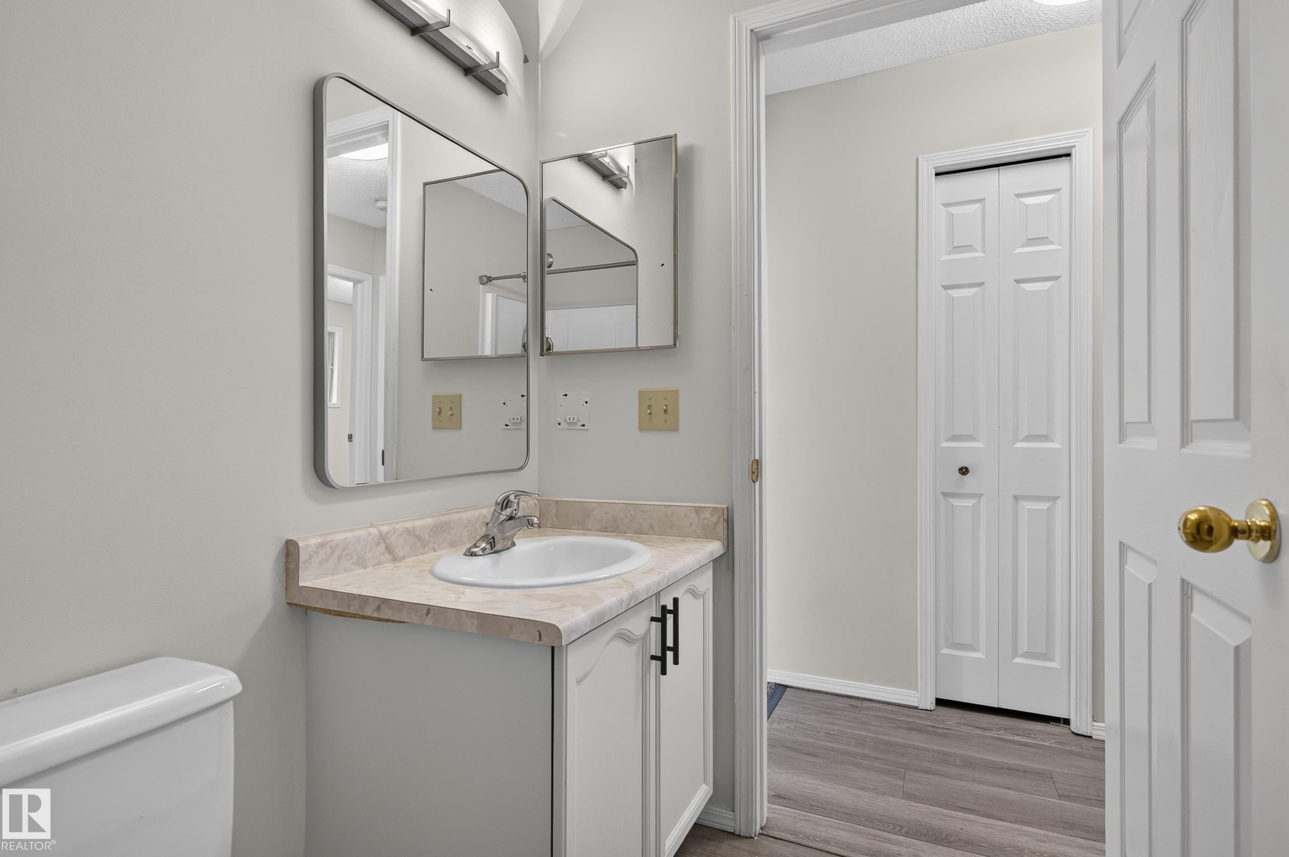 Vanity with a single basin sink, wall-mounted mirror, and overhead lighting - 3722 34A Avenue Nw, Edmonton, AB
