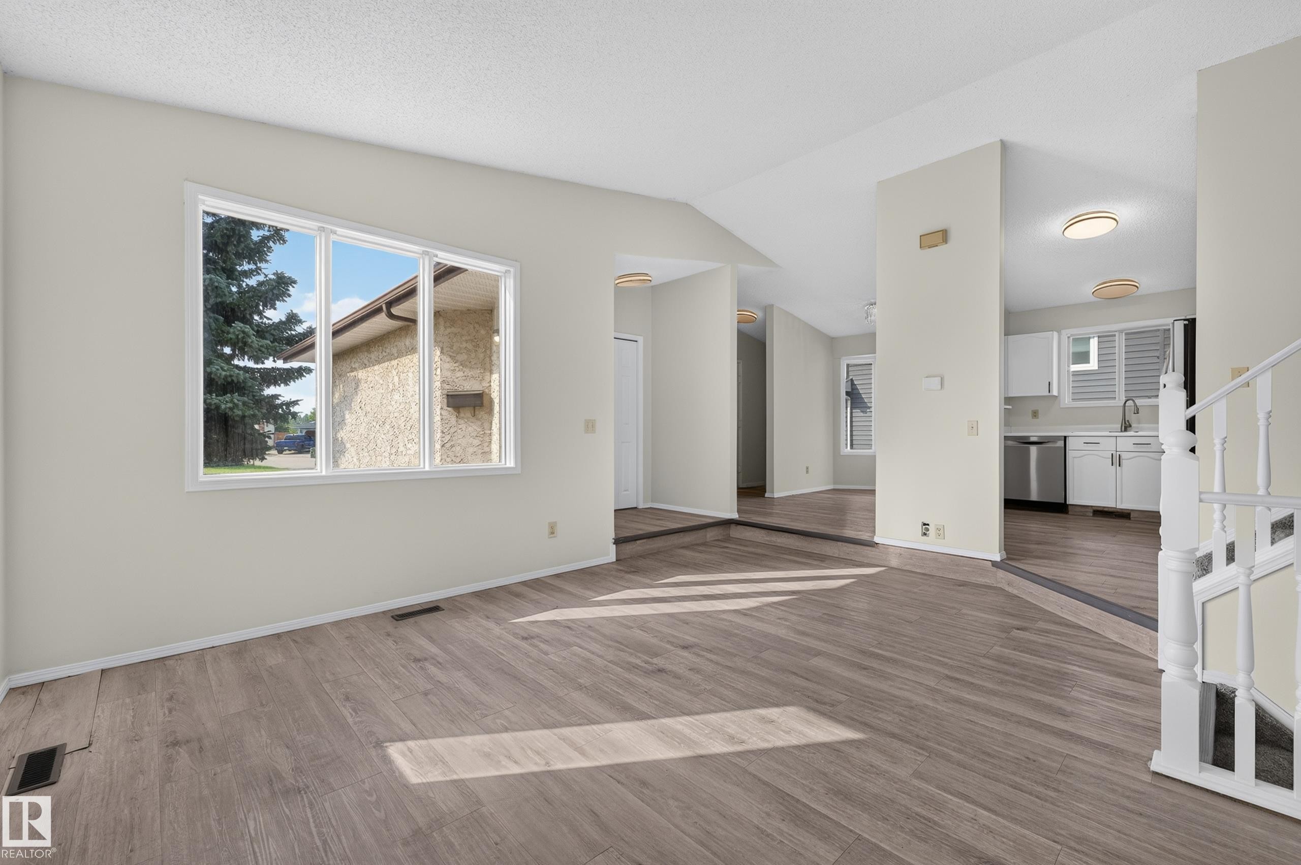 Wood-finish flooring, white walls, and a large window - 3722 34A Avenue Nw, Edmonton, AB