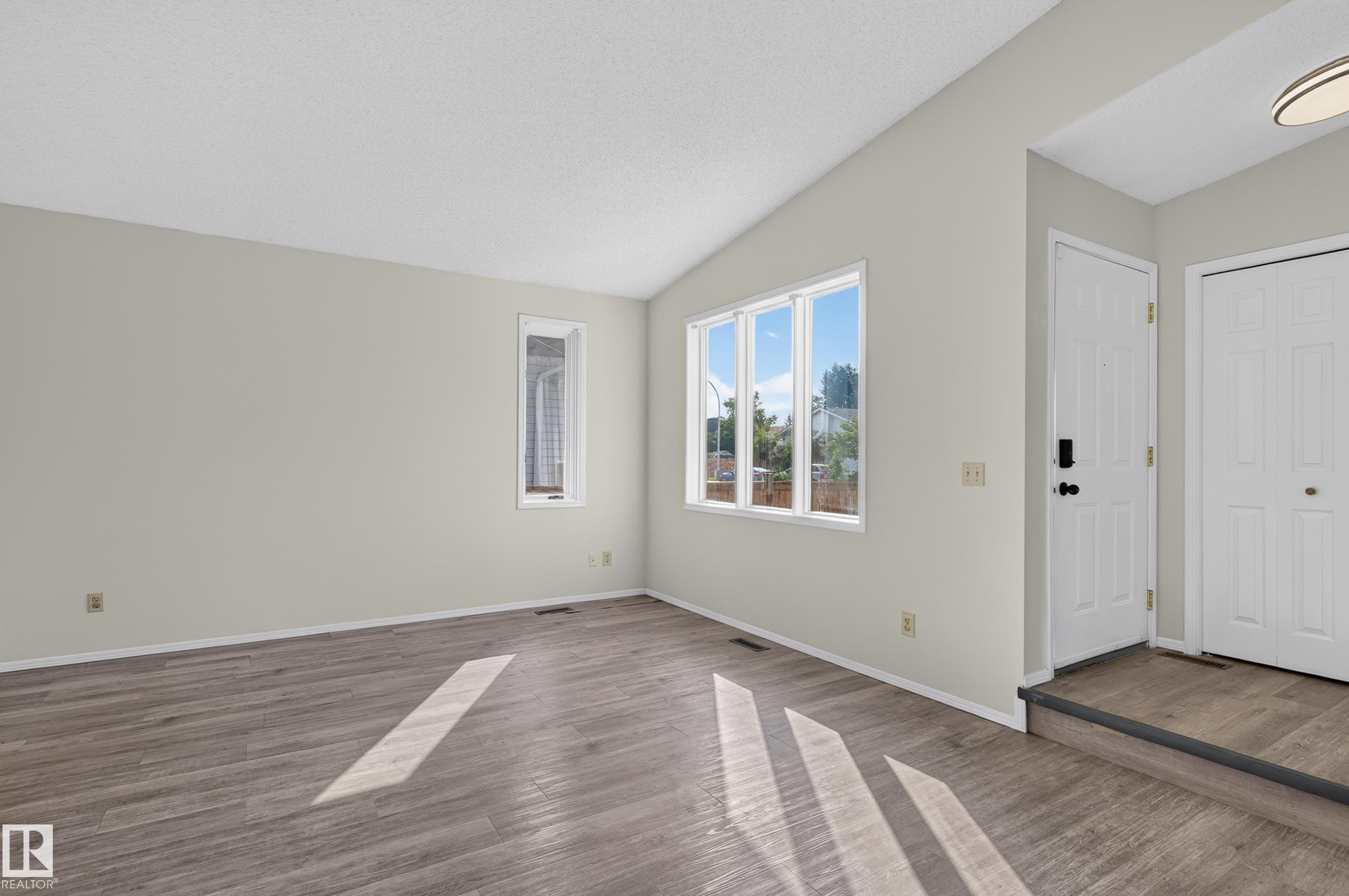 Vaulted ceiling, wood-finish flooring, multiple windows, white doors, recessed entry - 3722 34A Avenue Nw, Edmonton, AB