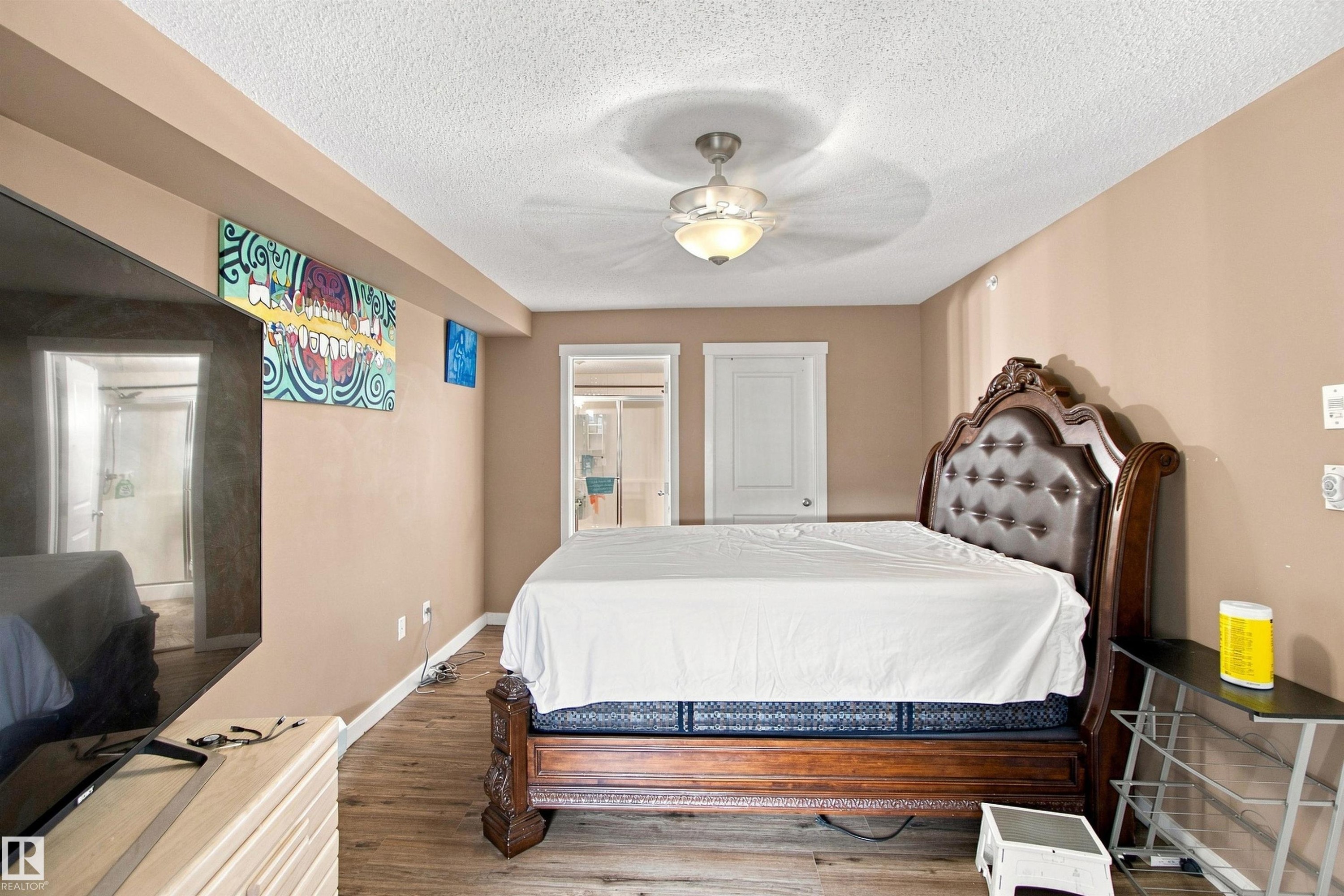 Wood-finish flooring, recessed ceiling, and a ceiling fan with integrated lighting - #413 18126 77 St Nw, Edmonton, AB