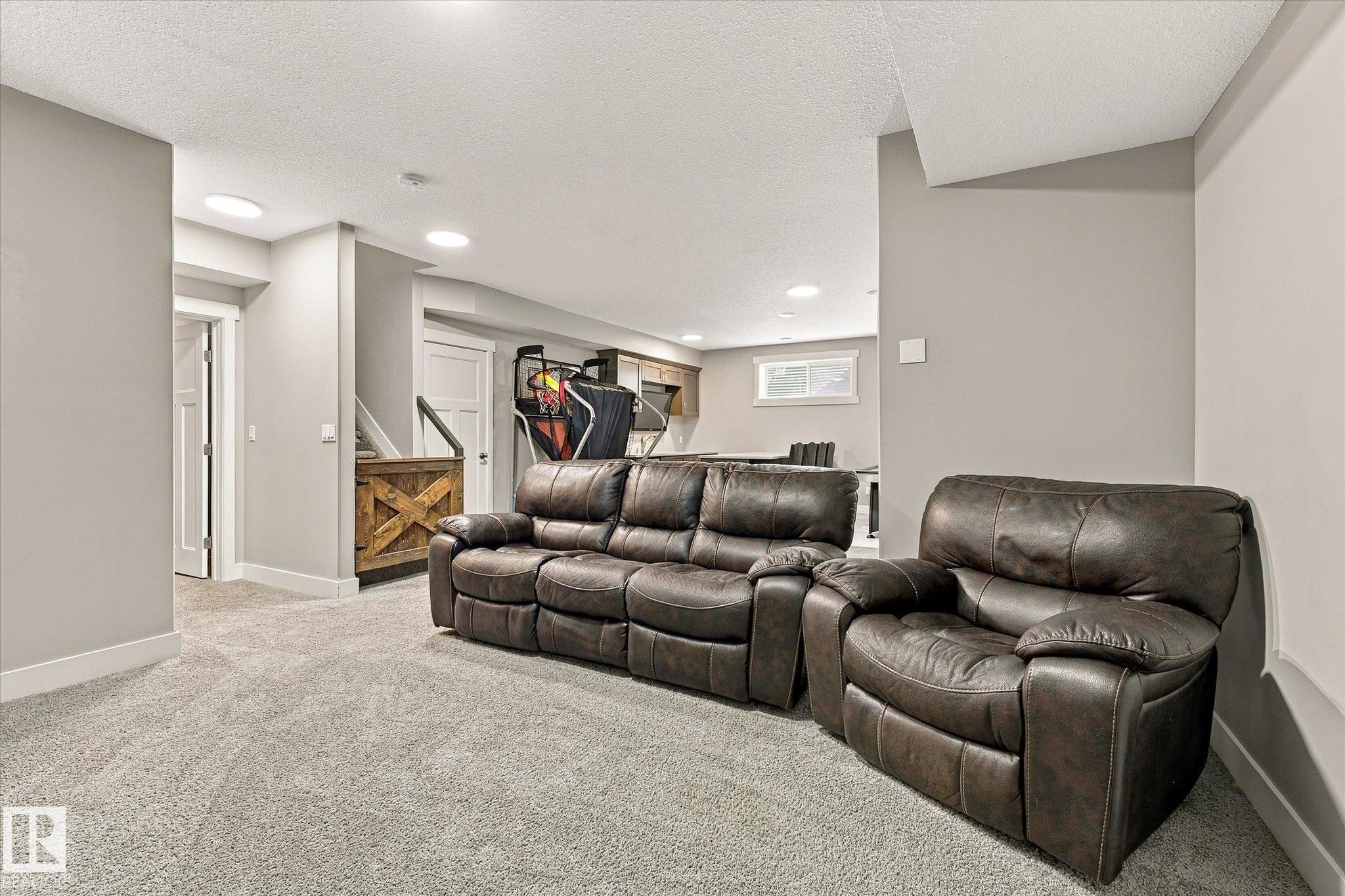 Recessed lighting illuminates the carpeted flooring and light grey walls - 2011 Genesis Lane, Stony Plain, AB