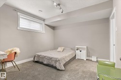 Carpeted flooring, recessed lighting, and a white window frame with blinds - 