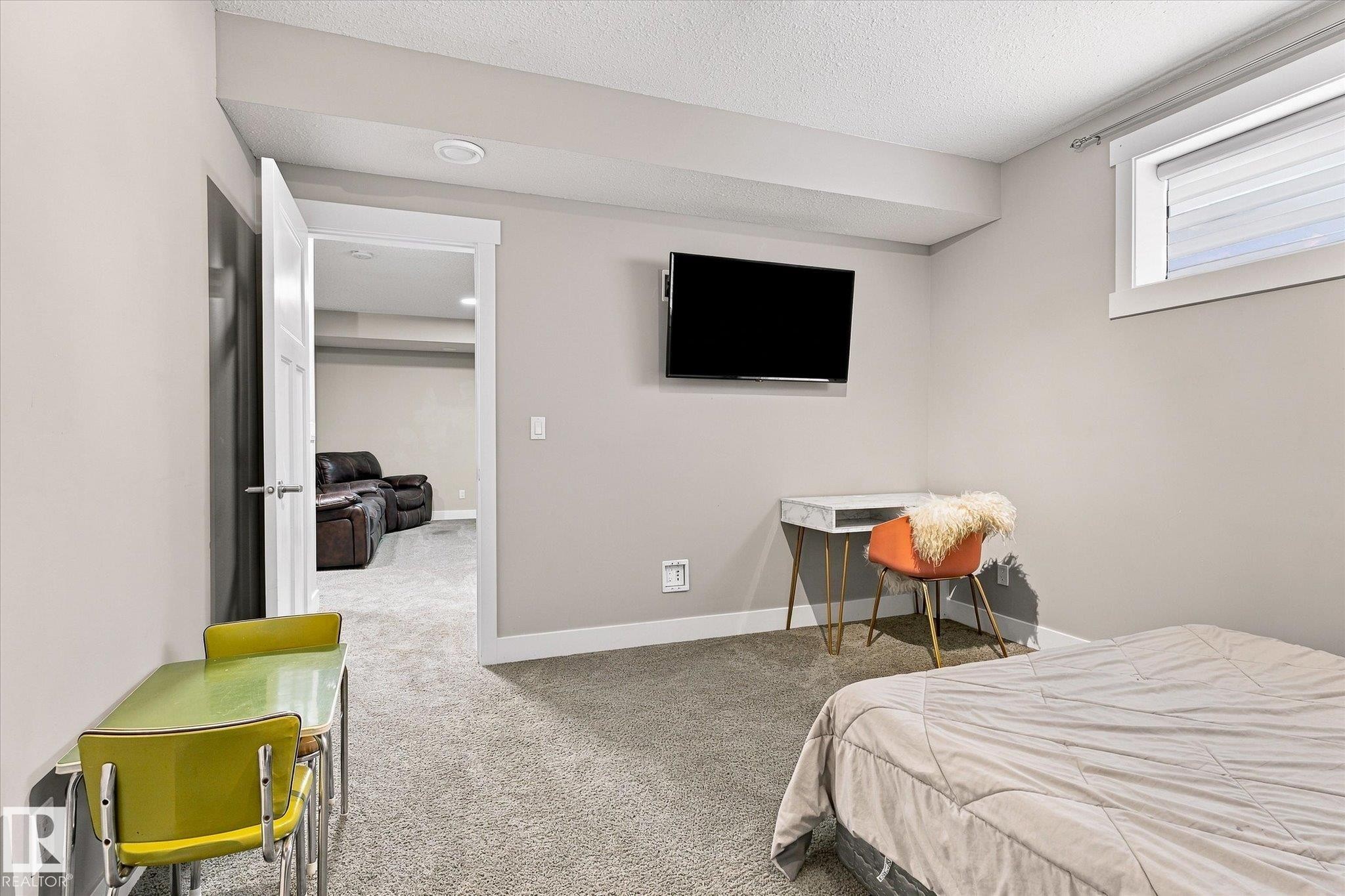 Recessed ceiling lighting, window with horizontal blinds, wall-mounted television bracket, and light gray wall paint - 2011 Genesis Lane, Stony Plain, AB