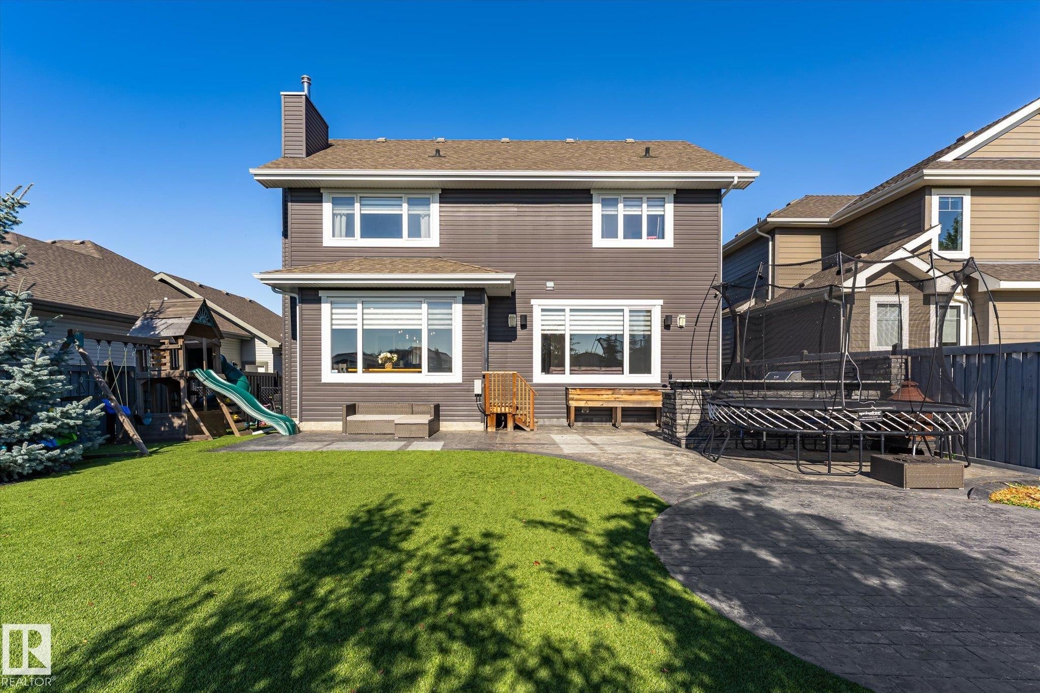 Two-story exterior with dark siding and white trim - 2011 Genesis Lane, Stony Plain, AB