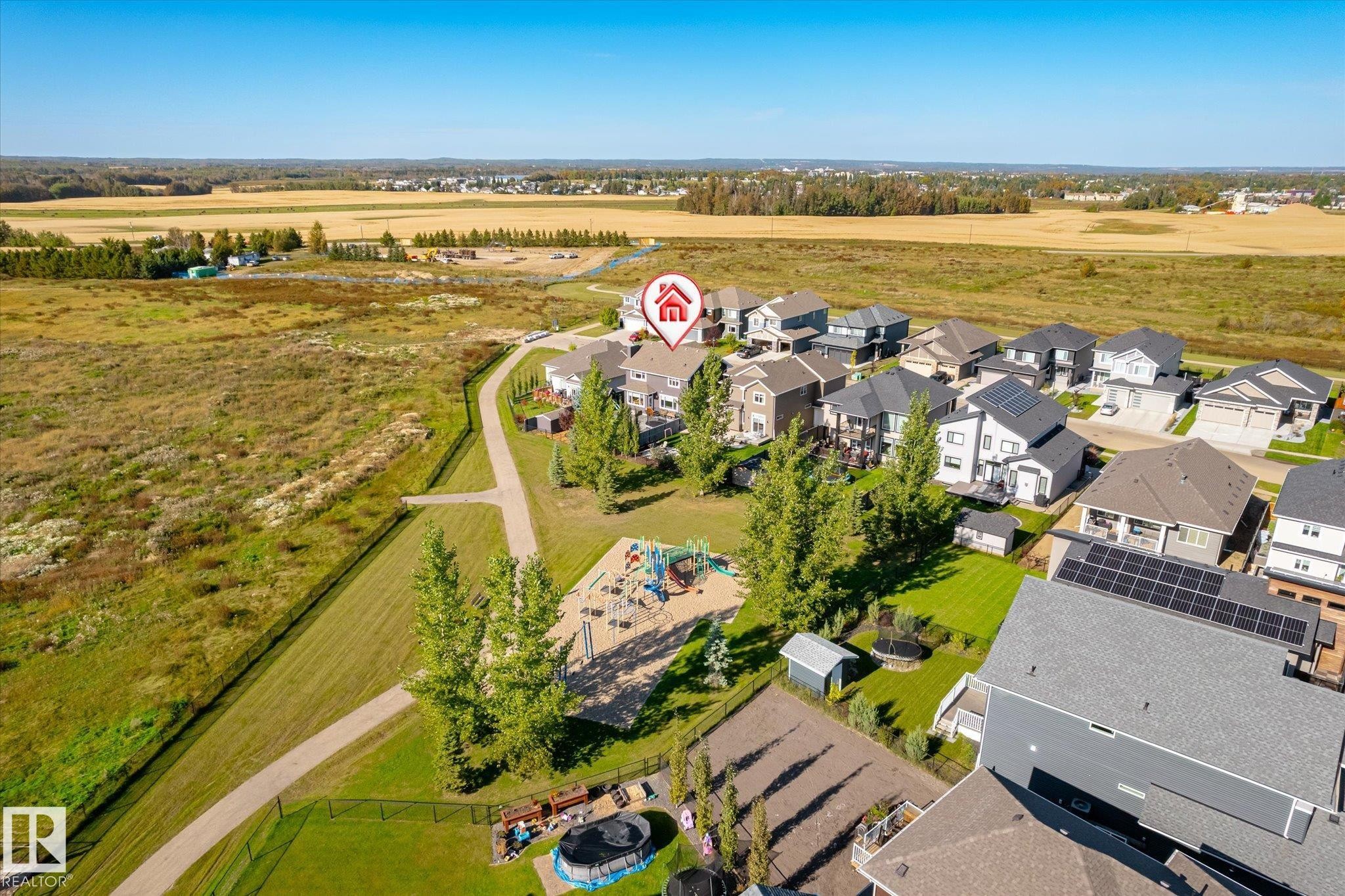 Residential area with a community playground, walking paths, and expansive natural landscape - 2011 Genesis Lane, Stony Plain, AB