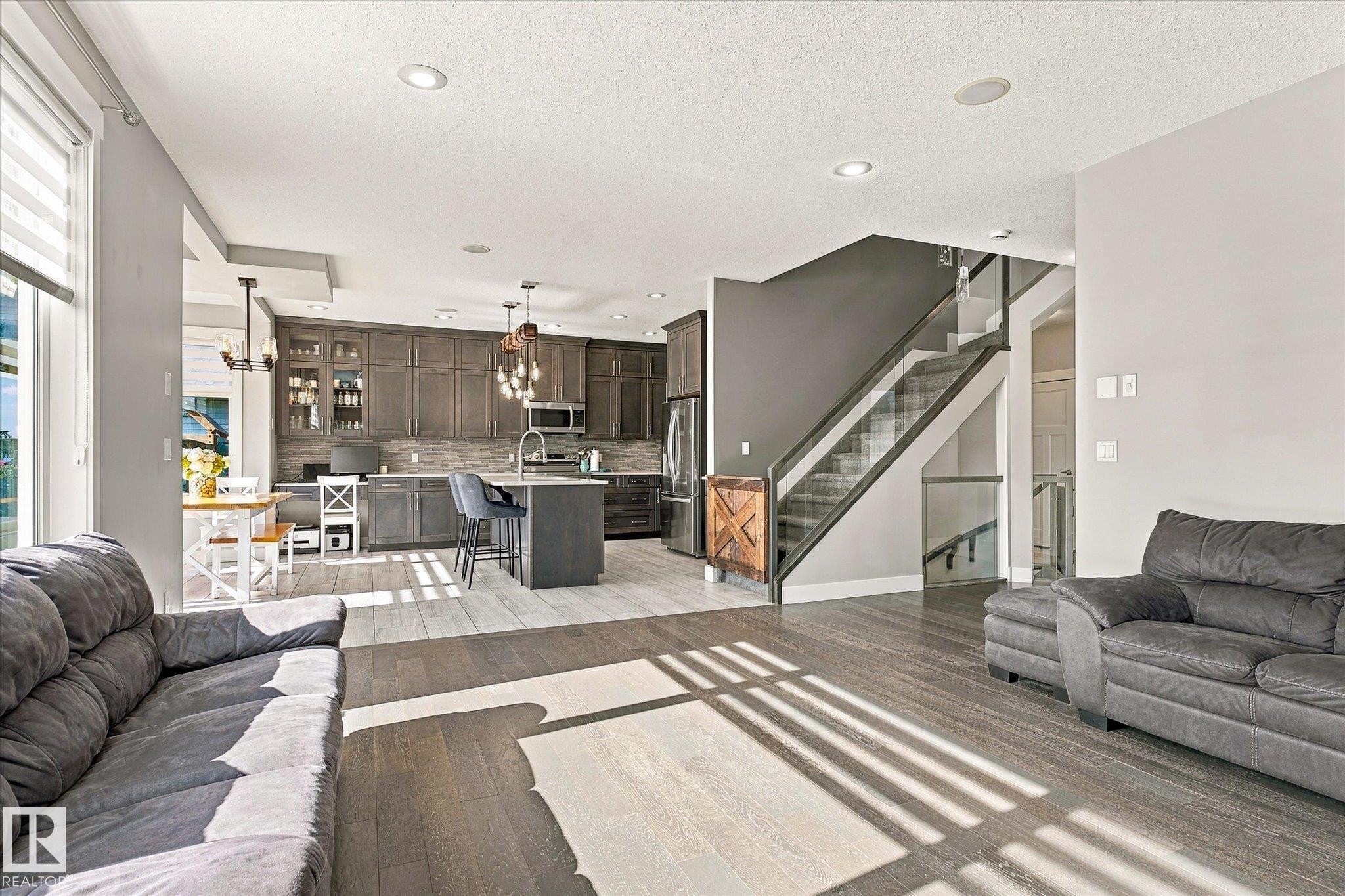 Open-concept living space with wood-finish flooring - 2011 Genesis Lane, Stony Plain, AB