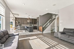 Open-concept living space with wood-finish flooring - 