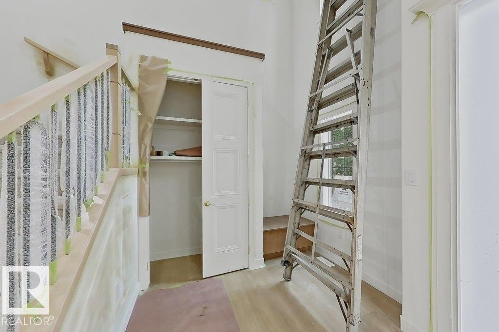 Staircase featuring wood handrails and balusters - 9216 91 Street Nw, Edmonton, AB - Indoor