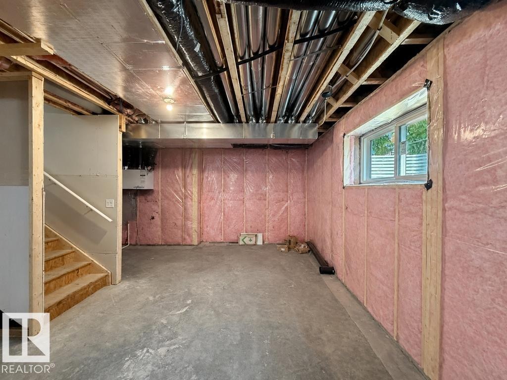 Expansive unfinished basement featuring concrete flooring, exposed ceiling joists, and insulated perimeter walls - 9216 91 Street Nw, Edmonton, AB - Outdoor With View