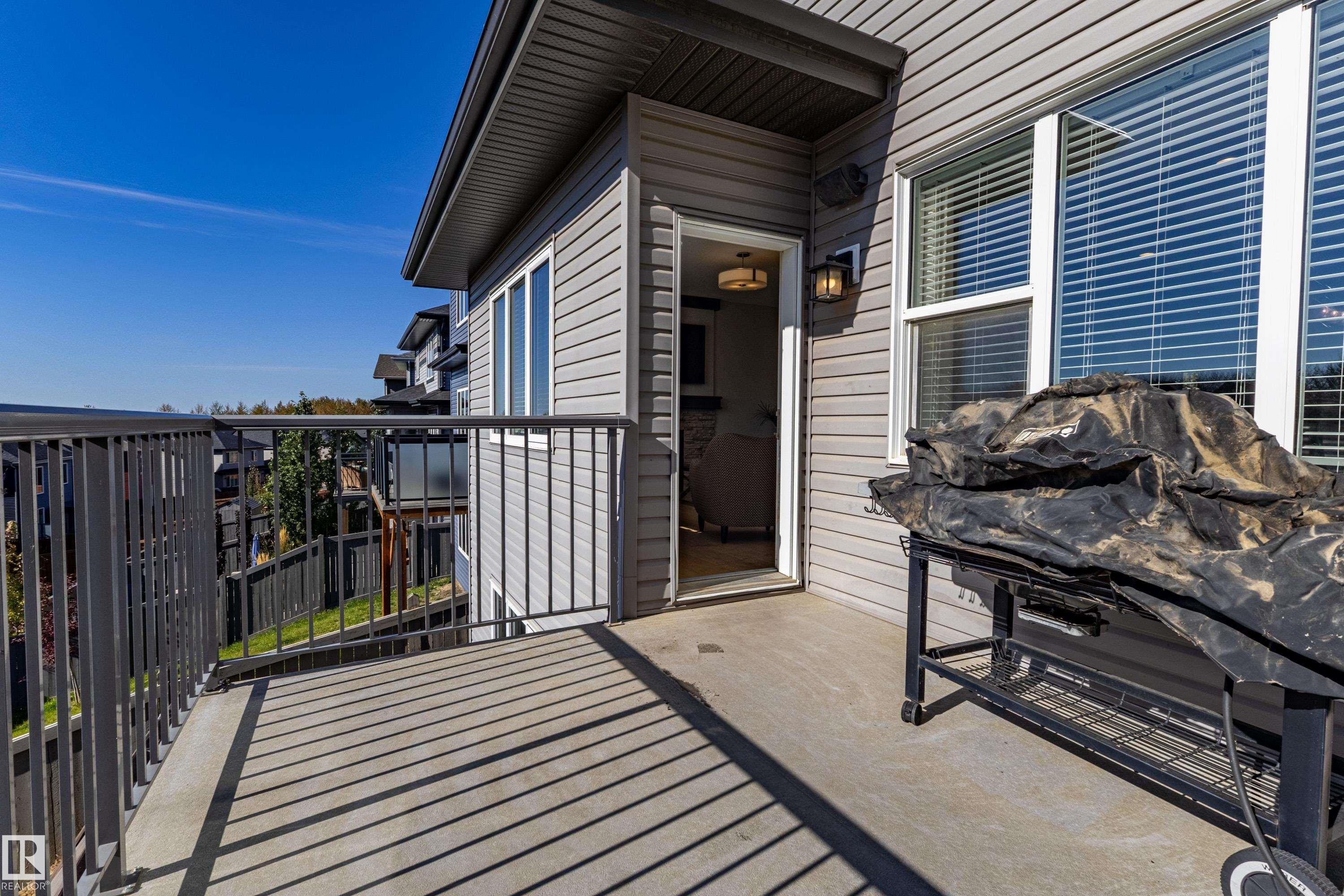 Exterior balcony with a concrete surface and metal railings - 233 Hawks Ridge Boulevard Nw, Edmonton, AB