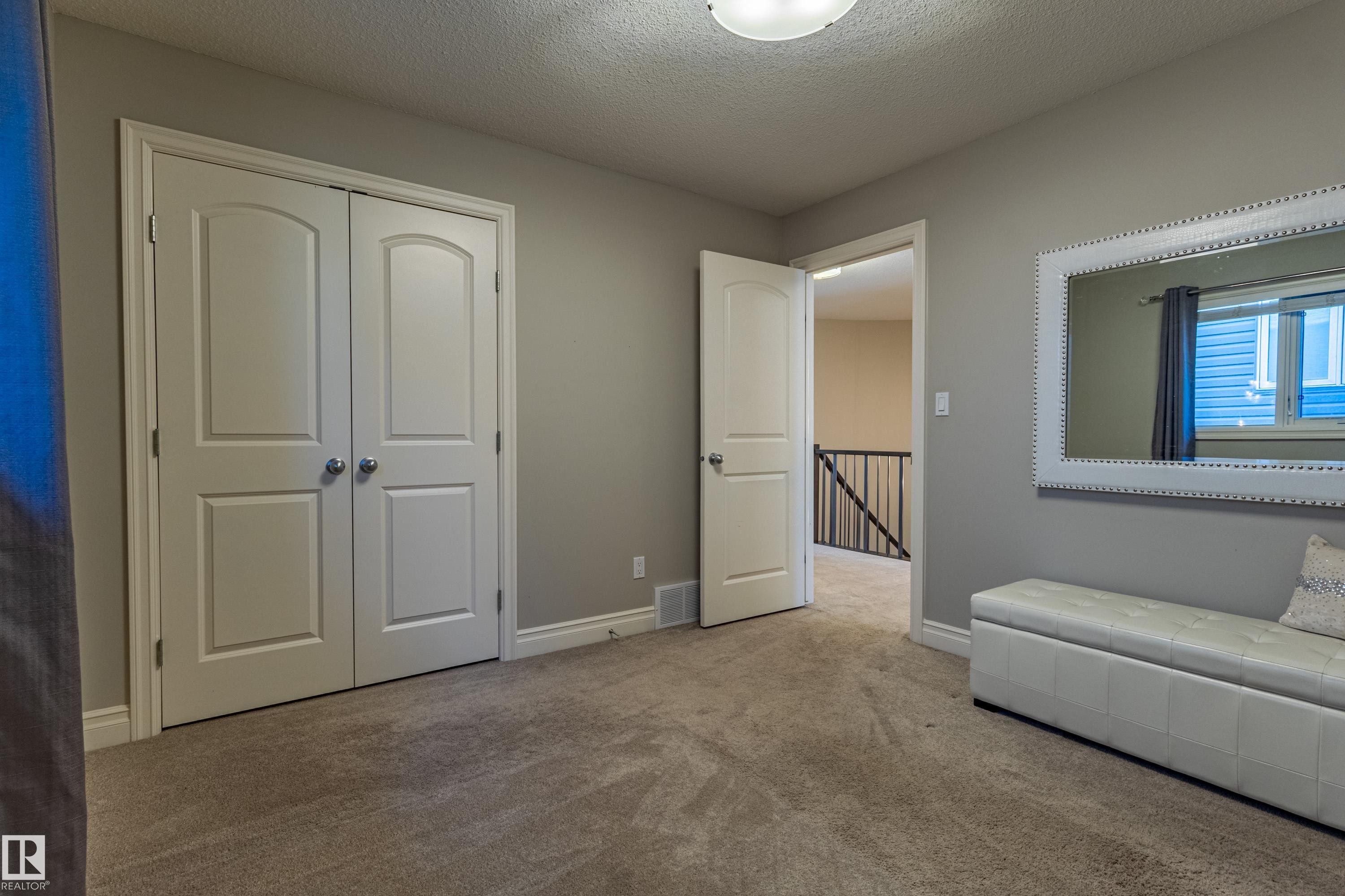 Light gray wall paint, recessed lighting, white trim, and carpeted flooring - 233 Hawks Ridge Boulevard Nw, Edmonton, AB
