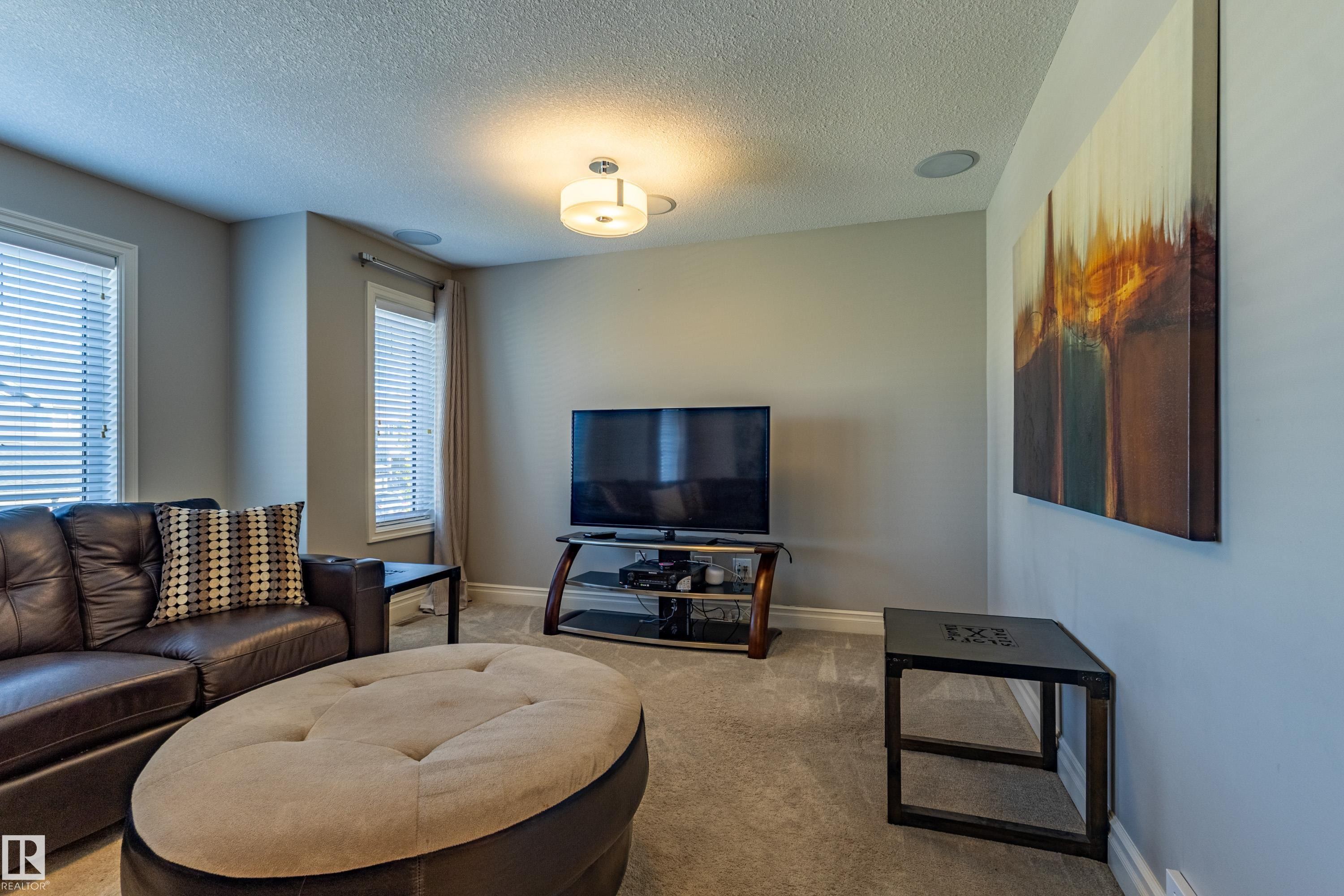 Recessed ceiling speakers, mounted ceiling light fixture, and two windows with blinds - 233 Hawks Ridge Boulevard Nw, Edmonton, AB