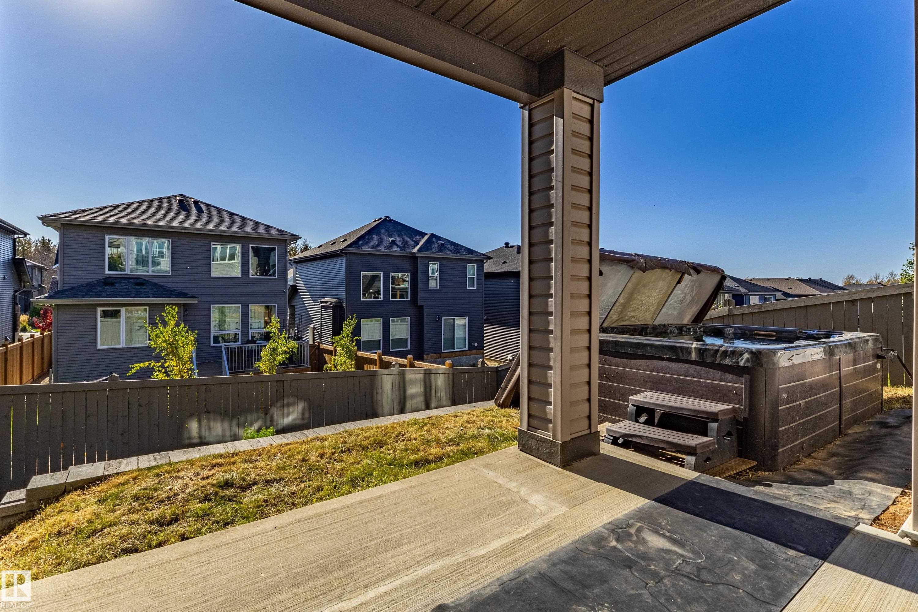 Concrete patio featuring an integrated spa - 233 Hawks Ridge Boulevard Nw, Edmonton, AB