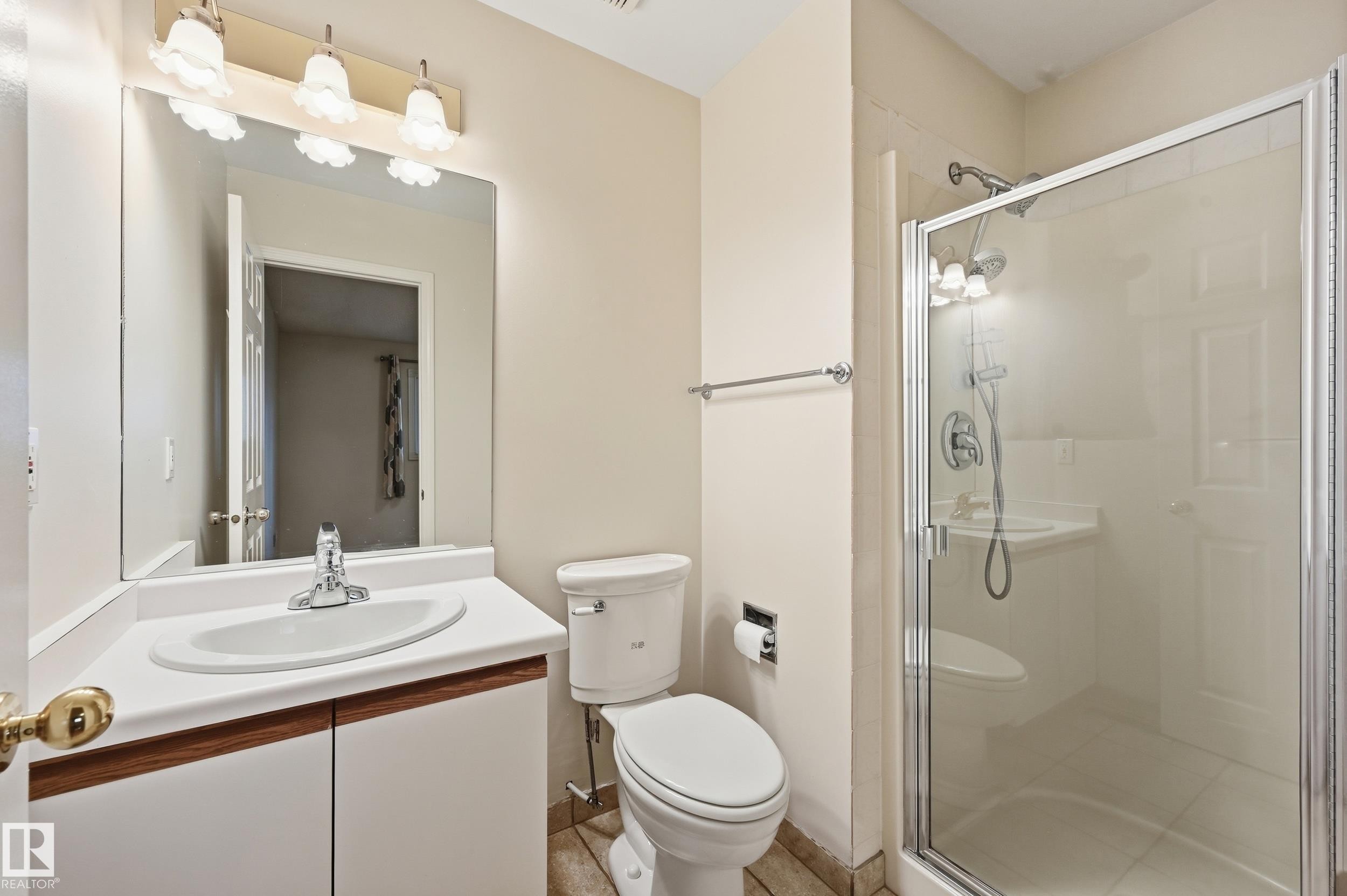 Vanity with integrated sink, chrome faucet, and wood-finish cabinetry - 11102 11A Avenue Nw, Edmonton, AB