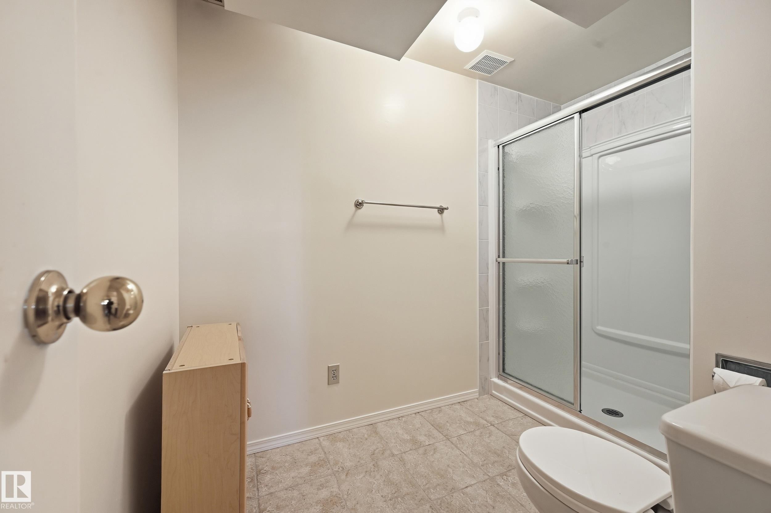 Tiled flooring with a stand-up shower featuring a sliding glass door - 11102 11A Avenue Nw, Edmonton, AB