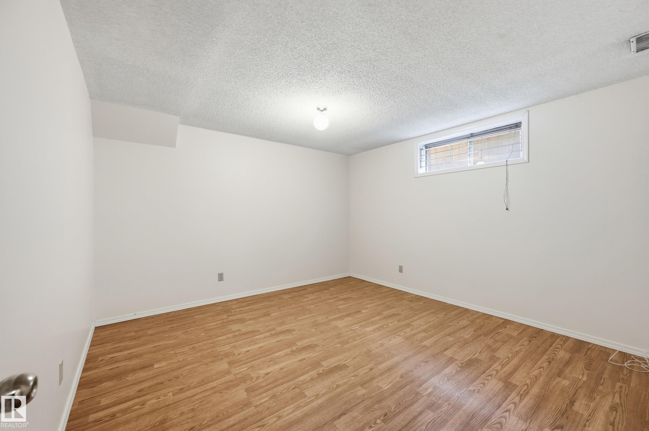 Wood-finish flooring, white walls, and a window with blinds - 11102 11A Avenue Nw, Edmonton, AB