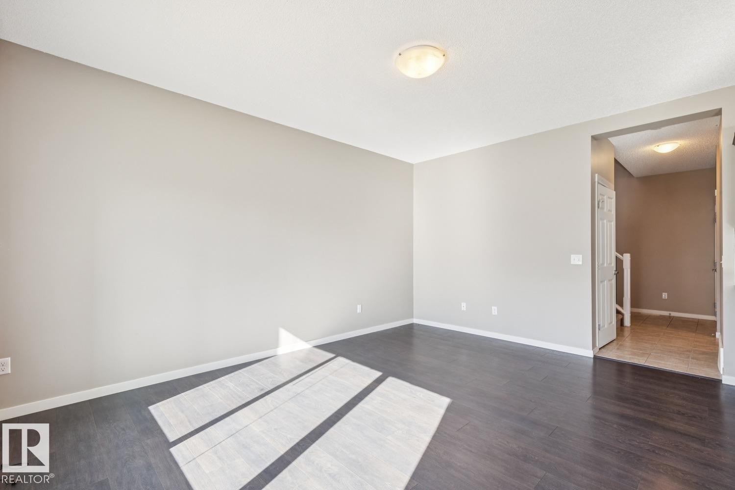 Dark wood-finish flooring complements light-toned walls - 12007 173 Avenue Nw, Edmonton, AB