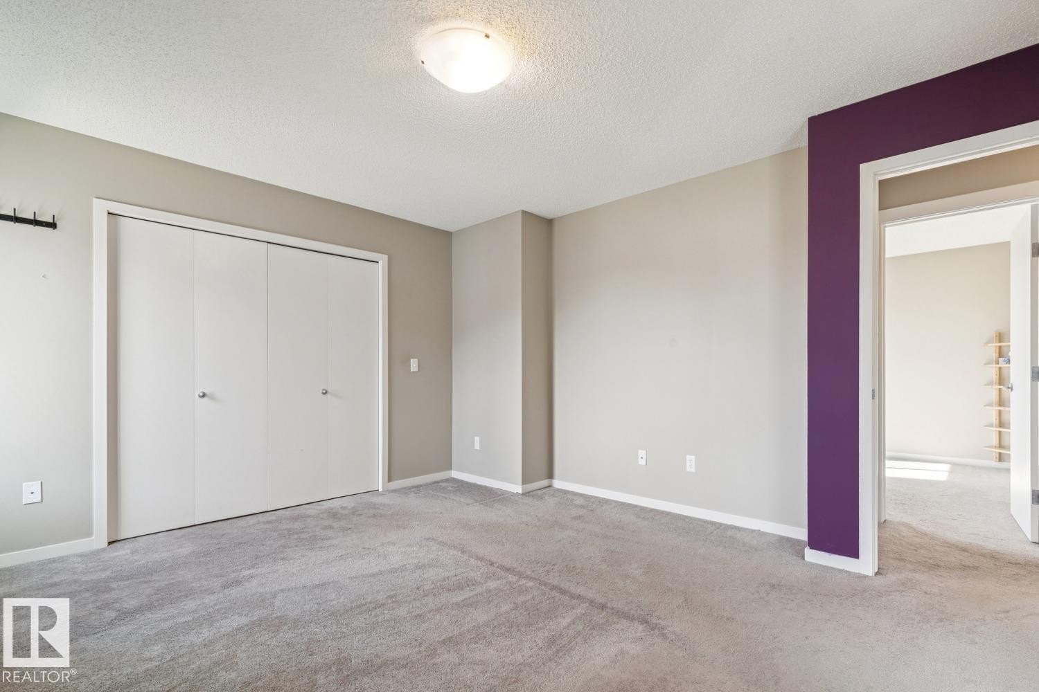 Broadloom carpeting, overhead flush mount lighting, and a closet with bifold doors - 12007 173 Avenue Nw, Edmonton, AB