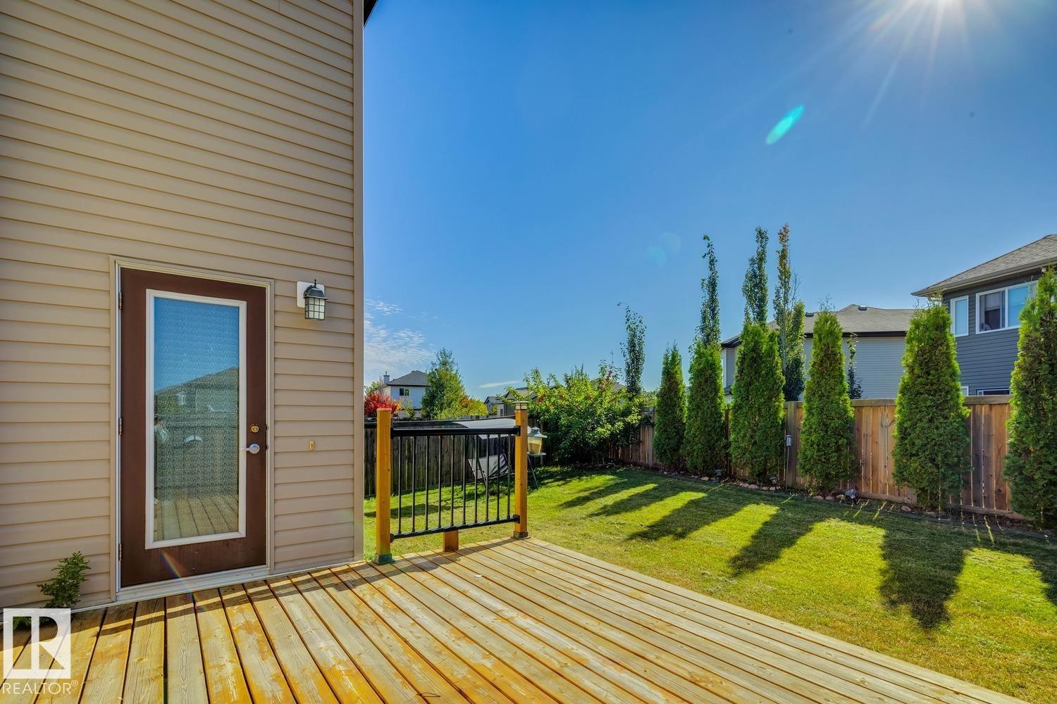 Expansive wood deck with black metal railing - 12007 173 Avenue Nw, Edmonton, AB