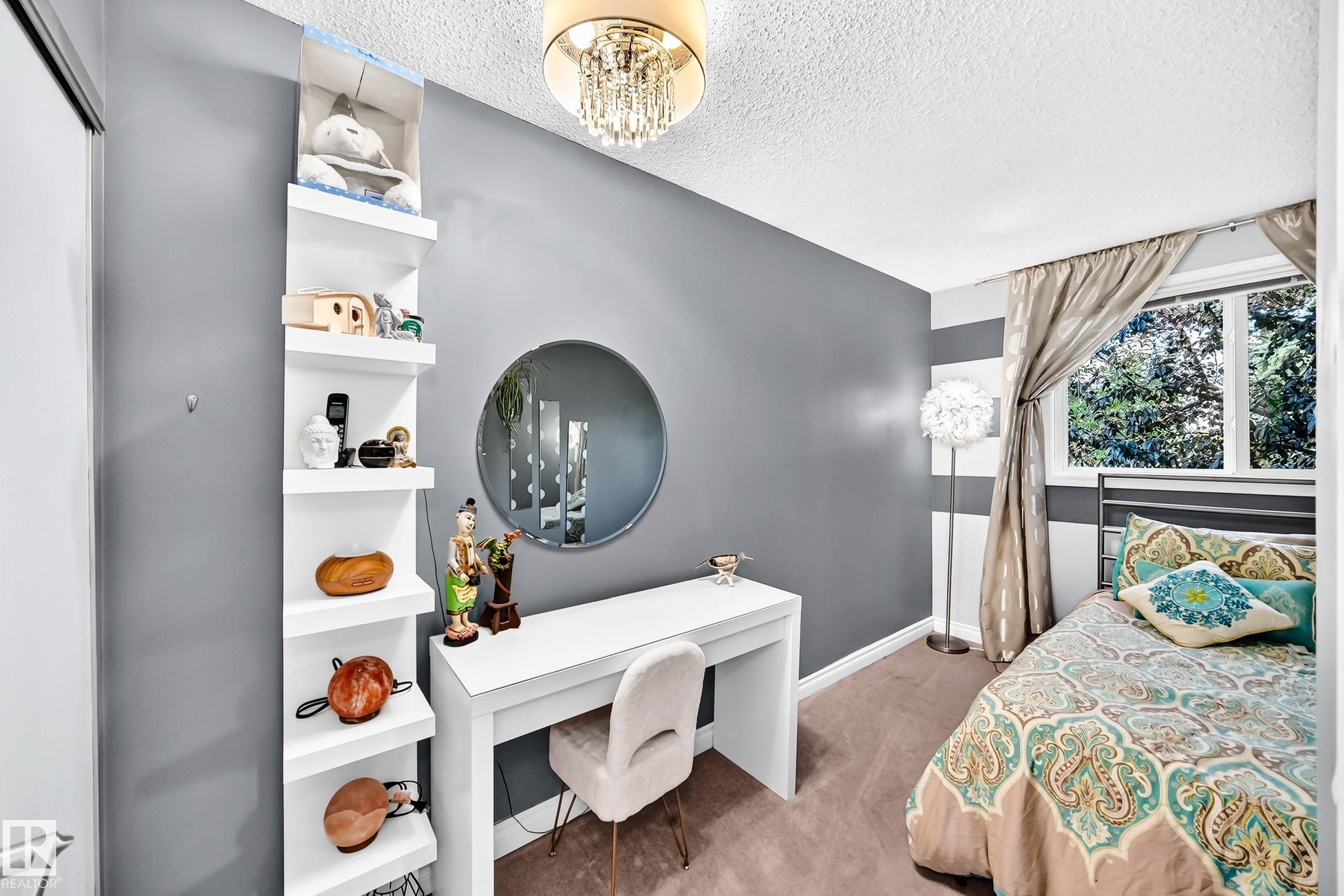 Recessed window with natural light, textured ceiling, wall-mounted shelving, built-in desk, and chandelier lighting fixture - 5620 93A Avenue Nw, Edmonton, AB