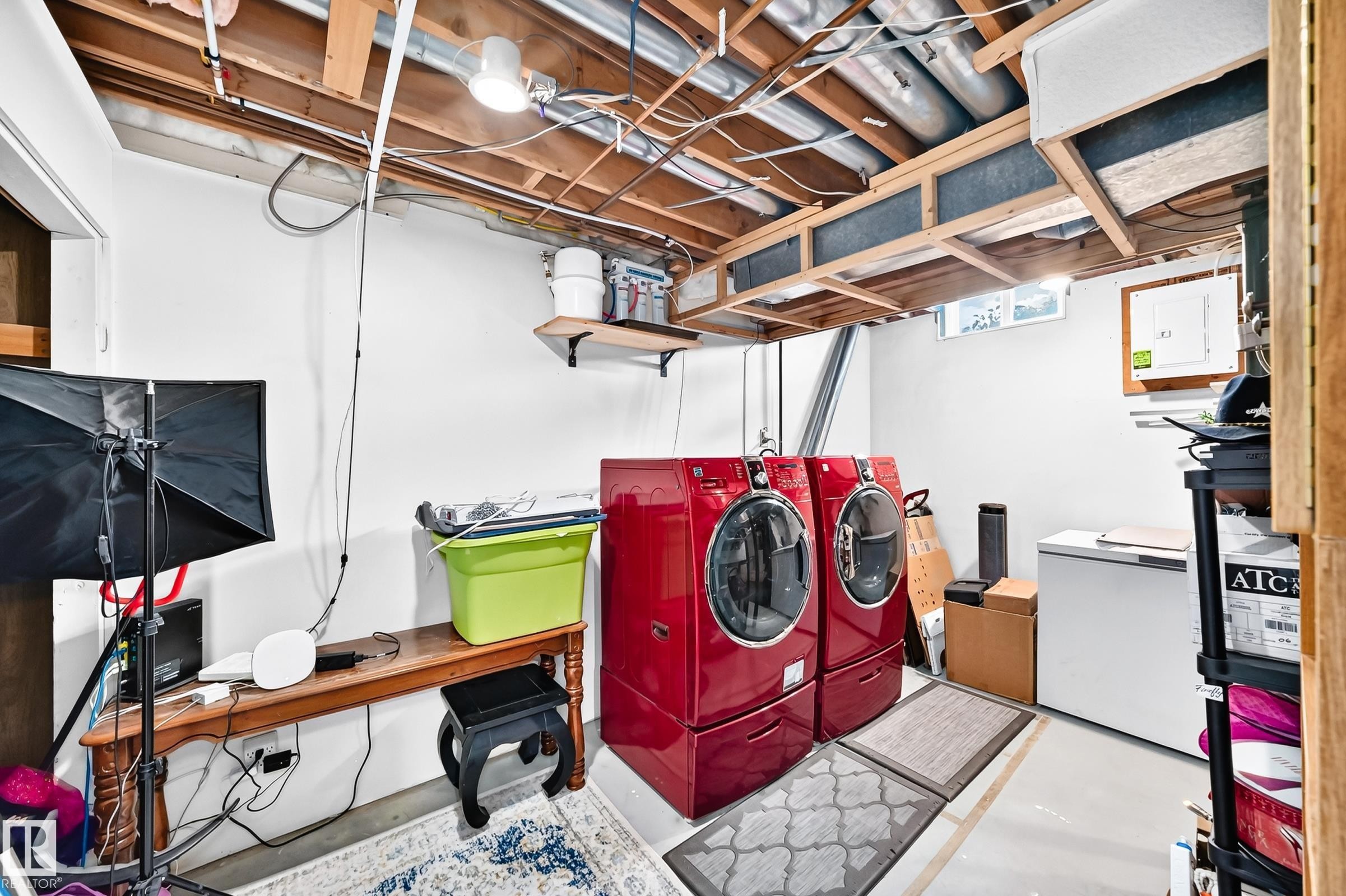 Utility space featuring exposed ceiling joists, white-painted walls, and concrete flooring - 5620 93A Avenue Nw, Edmonton, AB