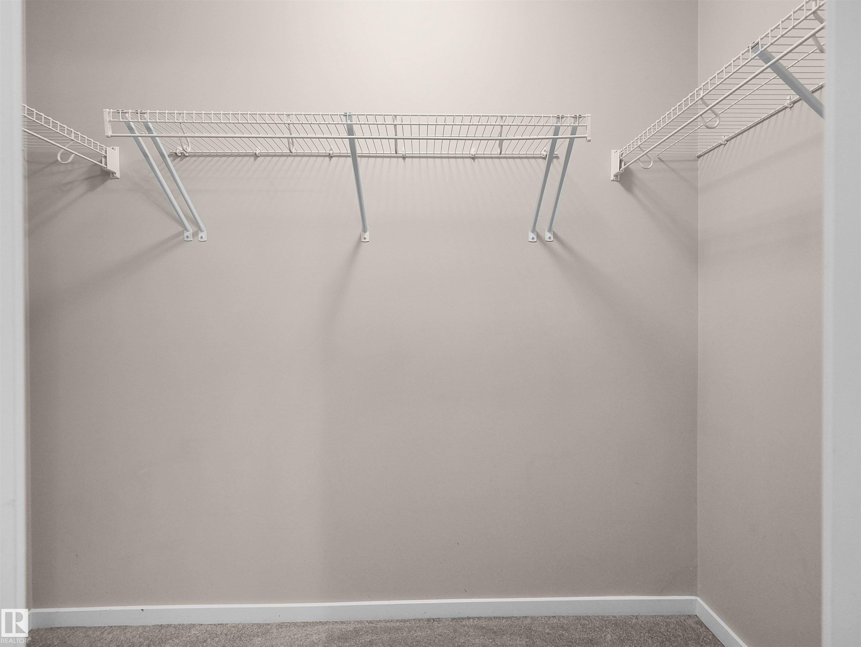 Closet featuring wall-mounted wire shelving and neutral wall paint - #162 603 Watt Bv Sw, Edmonton, AB