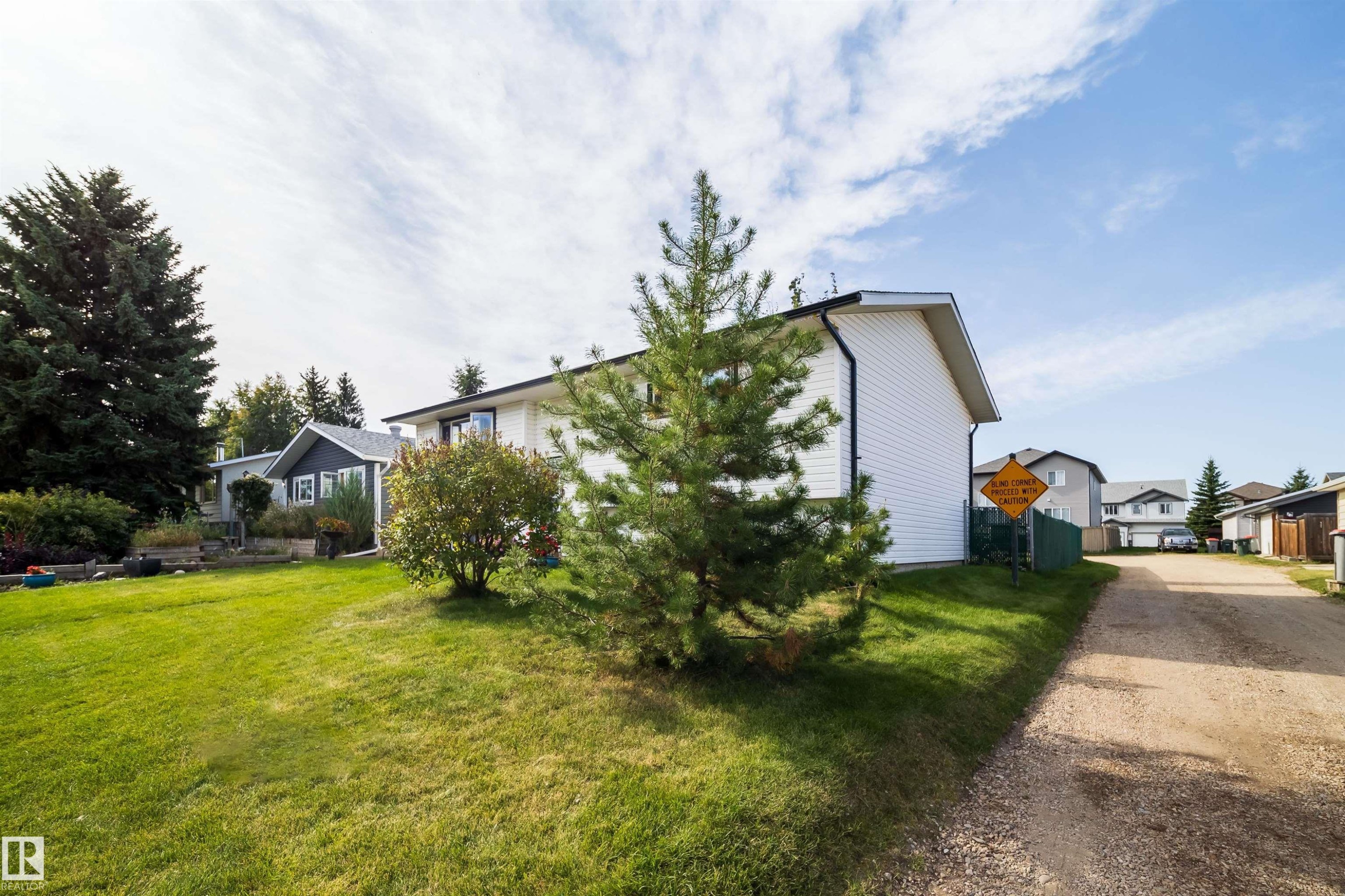 White-sided exterior with black trimmed roofing - 4104 44 Street, Stony Plain, AB