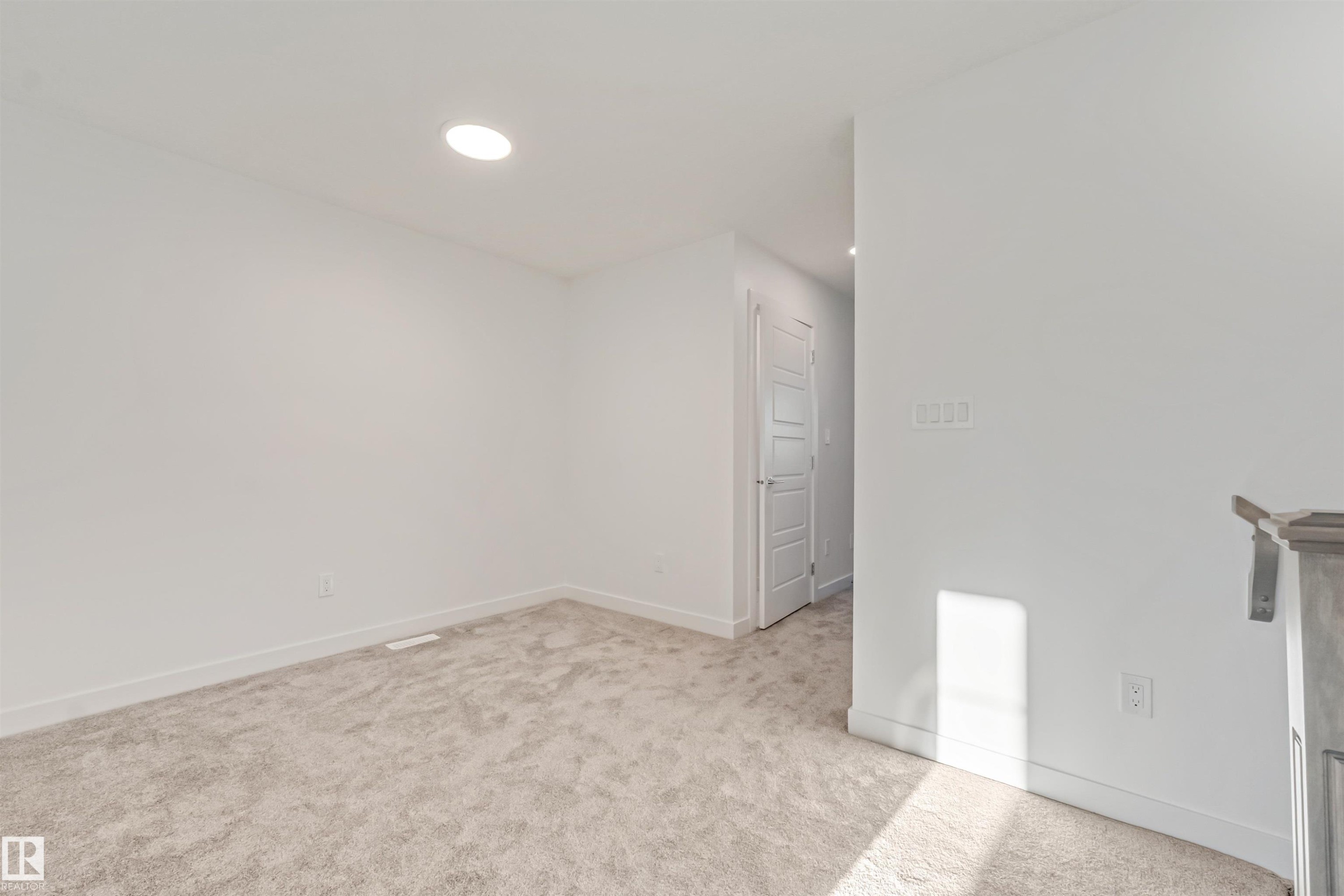 Recessed ceiling lighting, light gray carpeting, white walls, and a white paneled door - 1515 211 Street Nw, Edmonton, AB