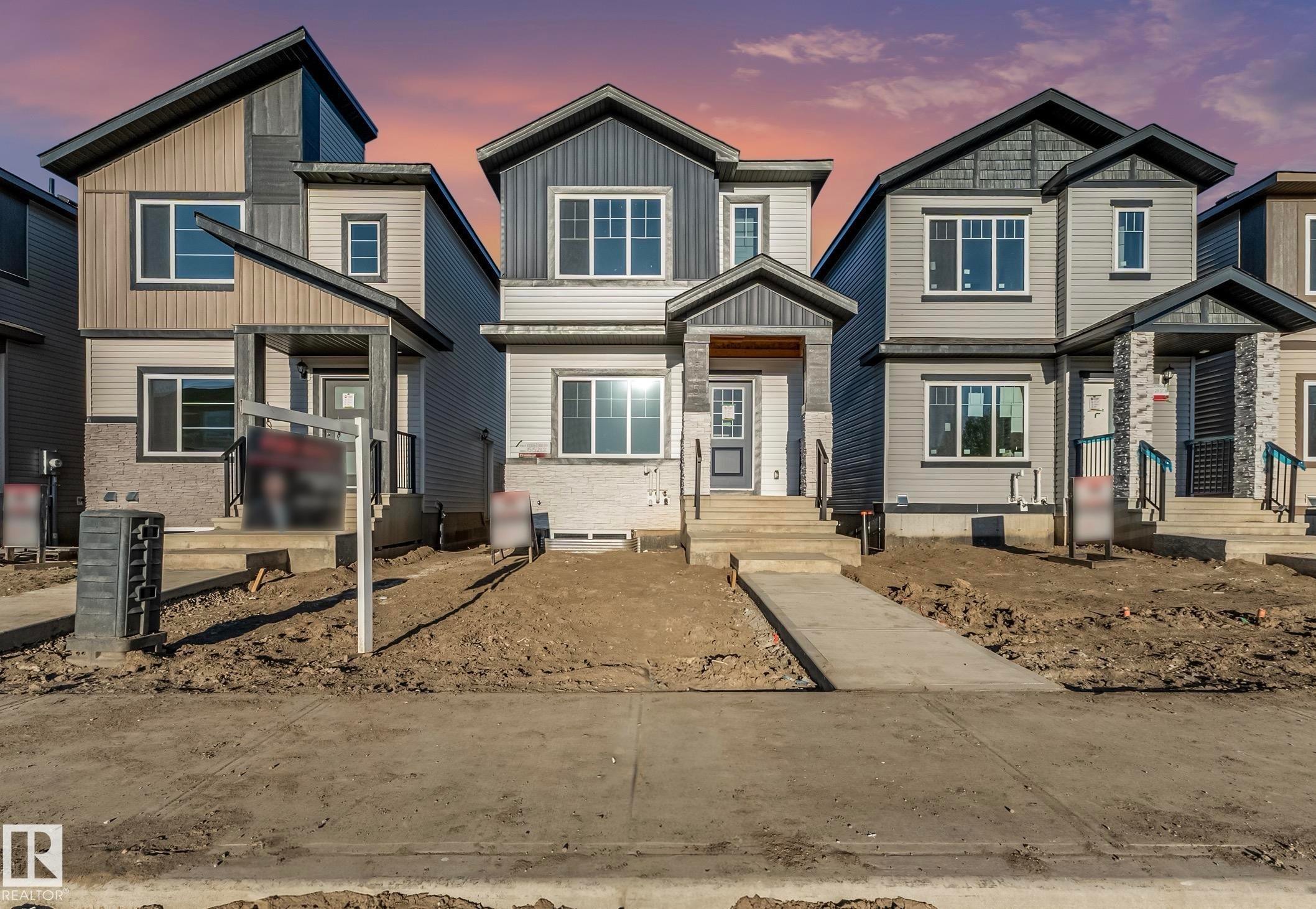 Modern architecture featuring multiple window styles, covered entryways, varied siding textures, and contrasting trim details - 1515 211 Street Nw, Edmonton, AB