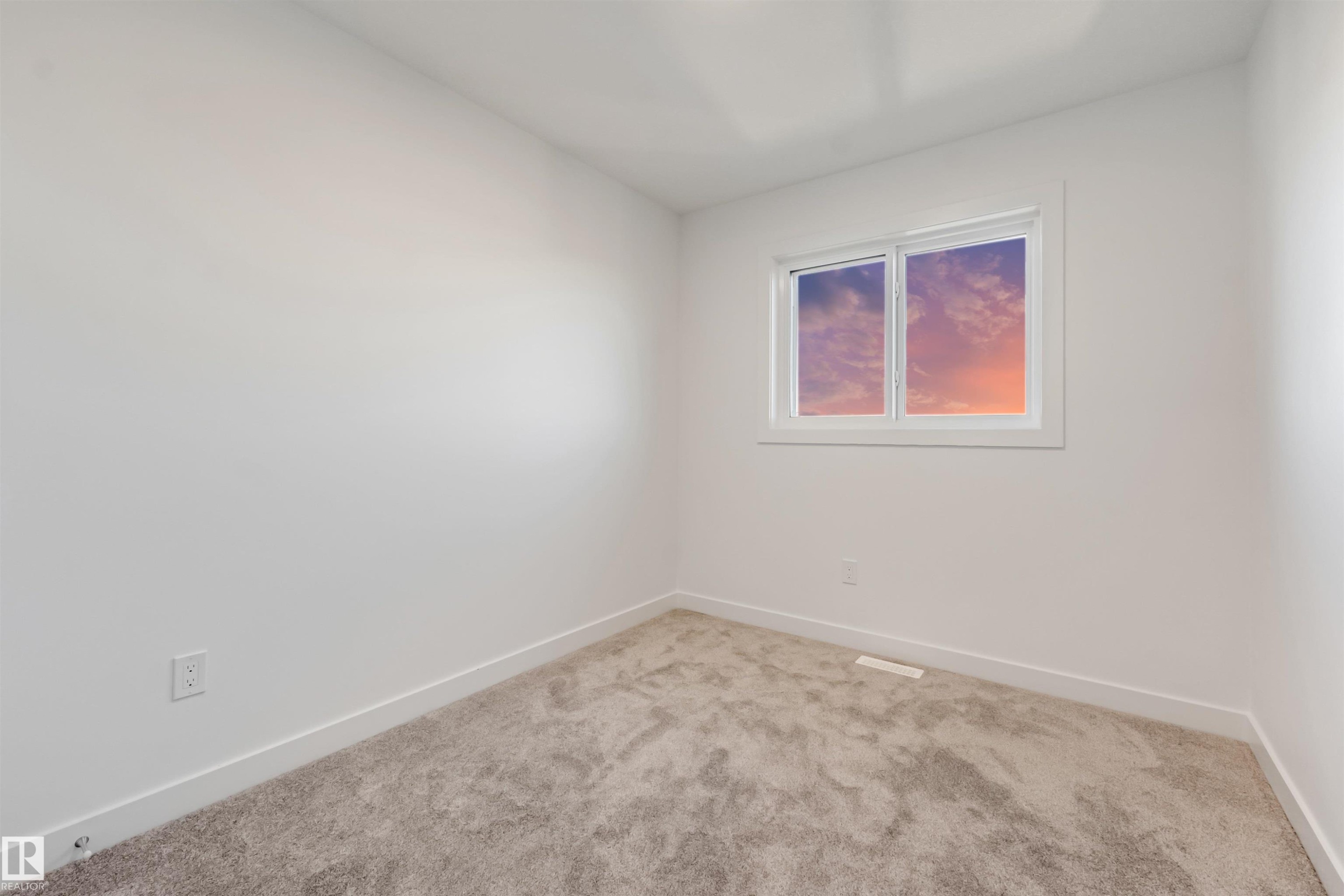 Neutral wall paint, carpet flooring, window with white trim, and white baseboards - 1515 211 Street Nw, Edmonton, AB