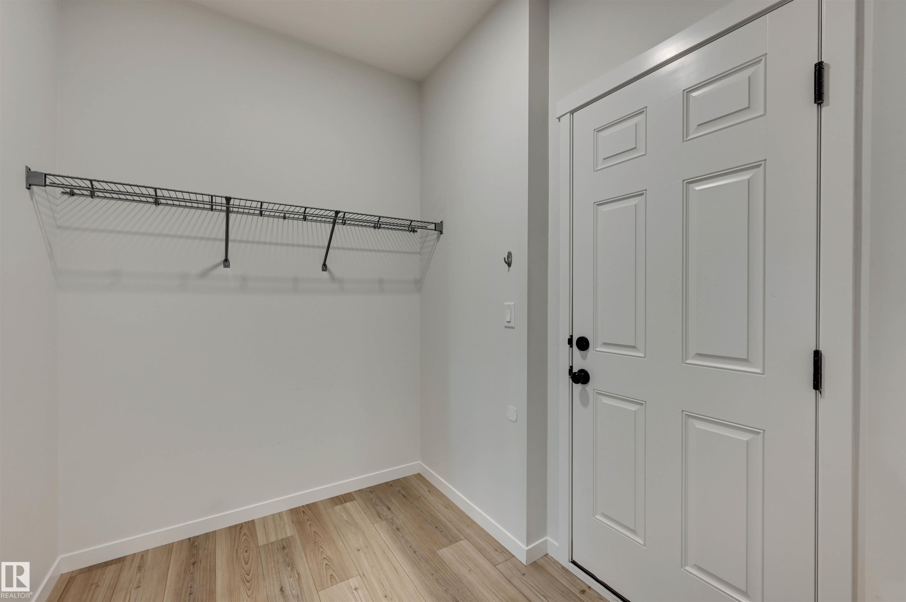 mud room from garage has door to close-off from entryway...because nobody needs to judge you and see your shoes and coats. - 1345 Westerra Drive, Stony Plain, AB