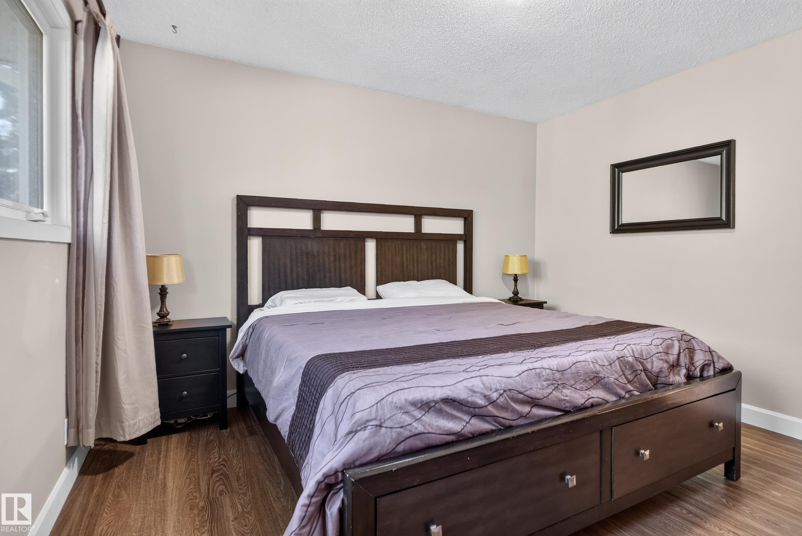 Wood-finish flooring with white trim - 14611 109 Avenue Nw, Edmonton, AB