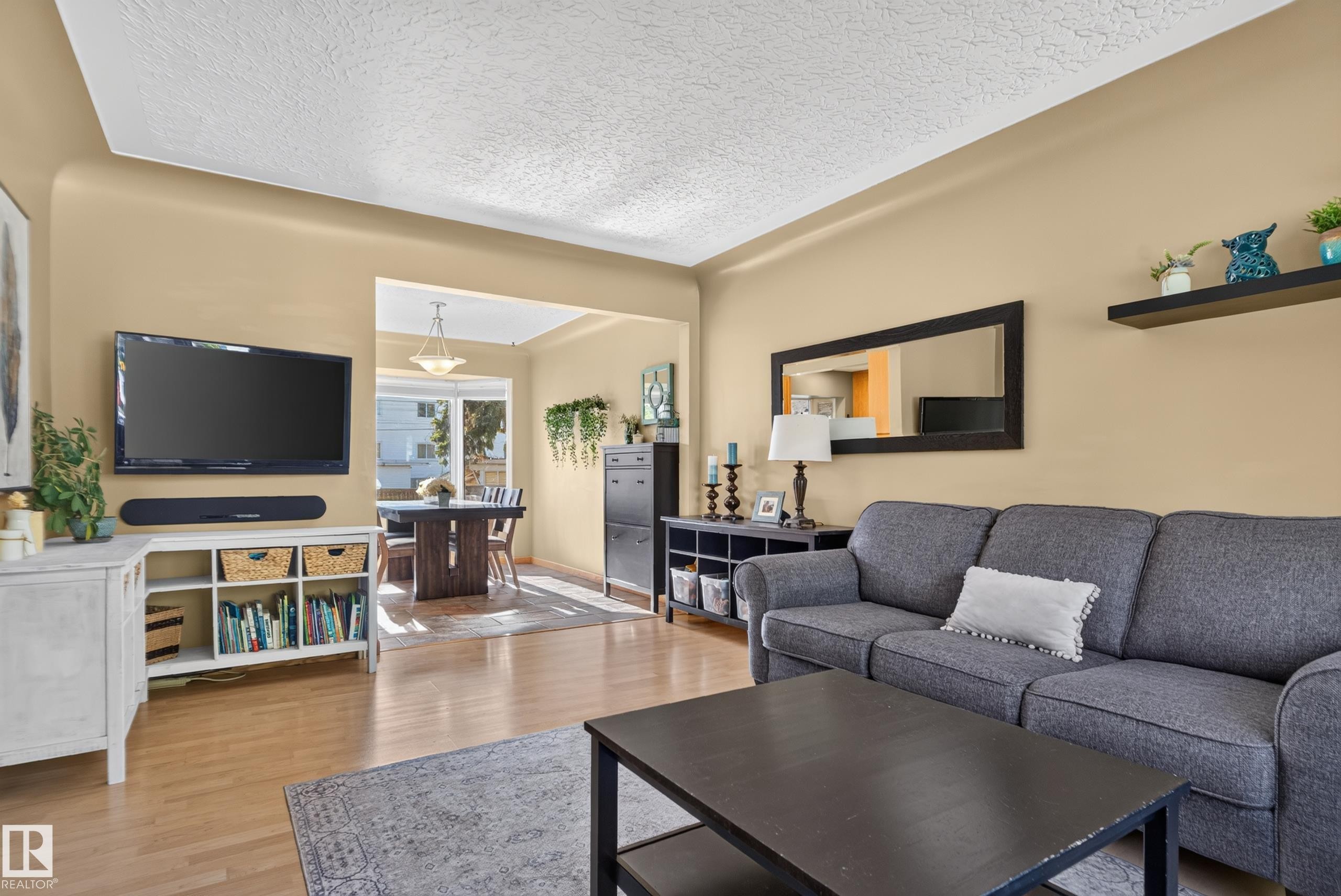 Hardwood-style flooring throughout, recessed entryway, and a dining area with dual windows - 14611 109 Avenue Nw, Edmonton, AB
