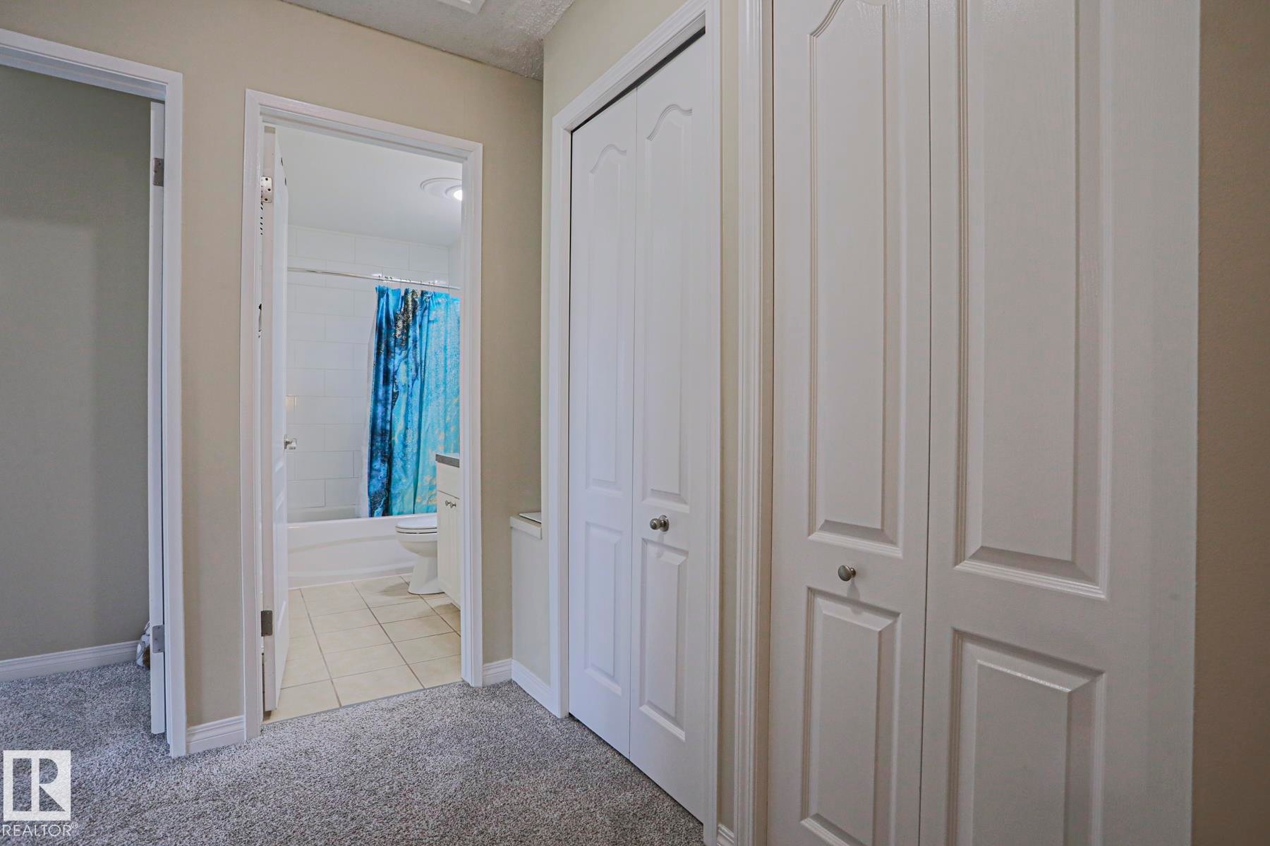 Wall-to-wall carpeting with multiple built-in storage closets, offering ample storage - 319 Telford Court, Leduc, AB
