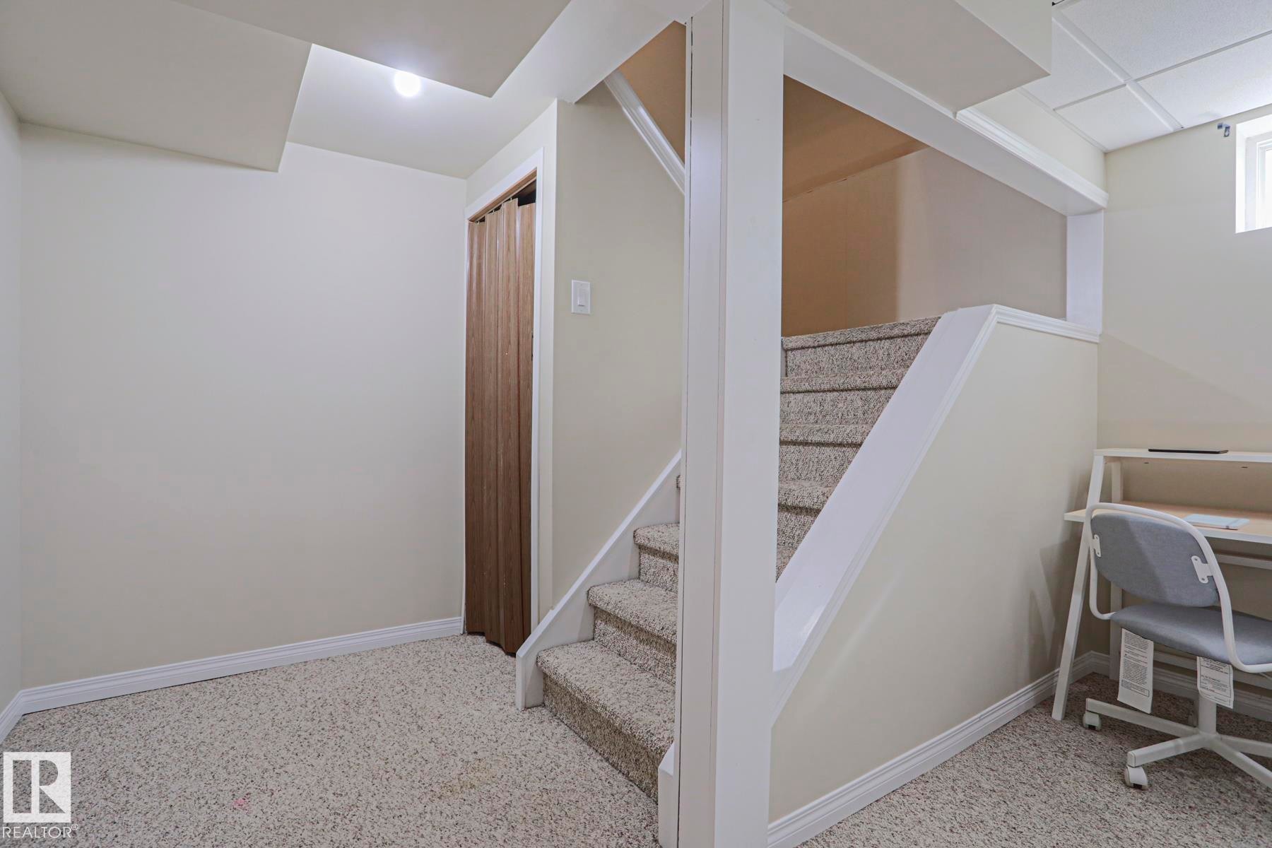 Carpeted flooring, painted walls, and a window - 319 Telford Court, Leduc, AB