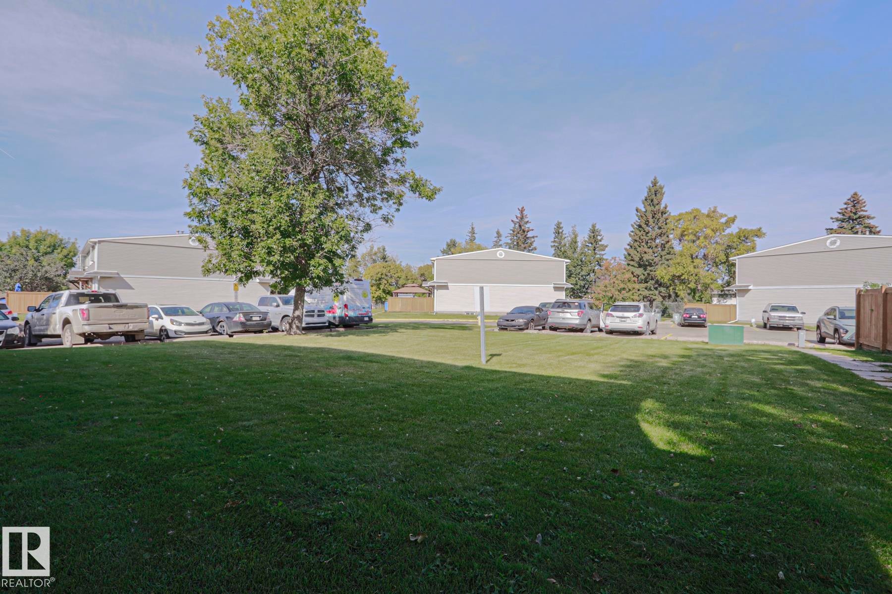 Expansive green space with mature trees - 319 Telford Court, Leduc, AB