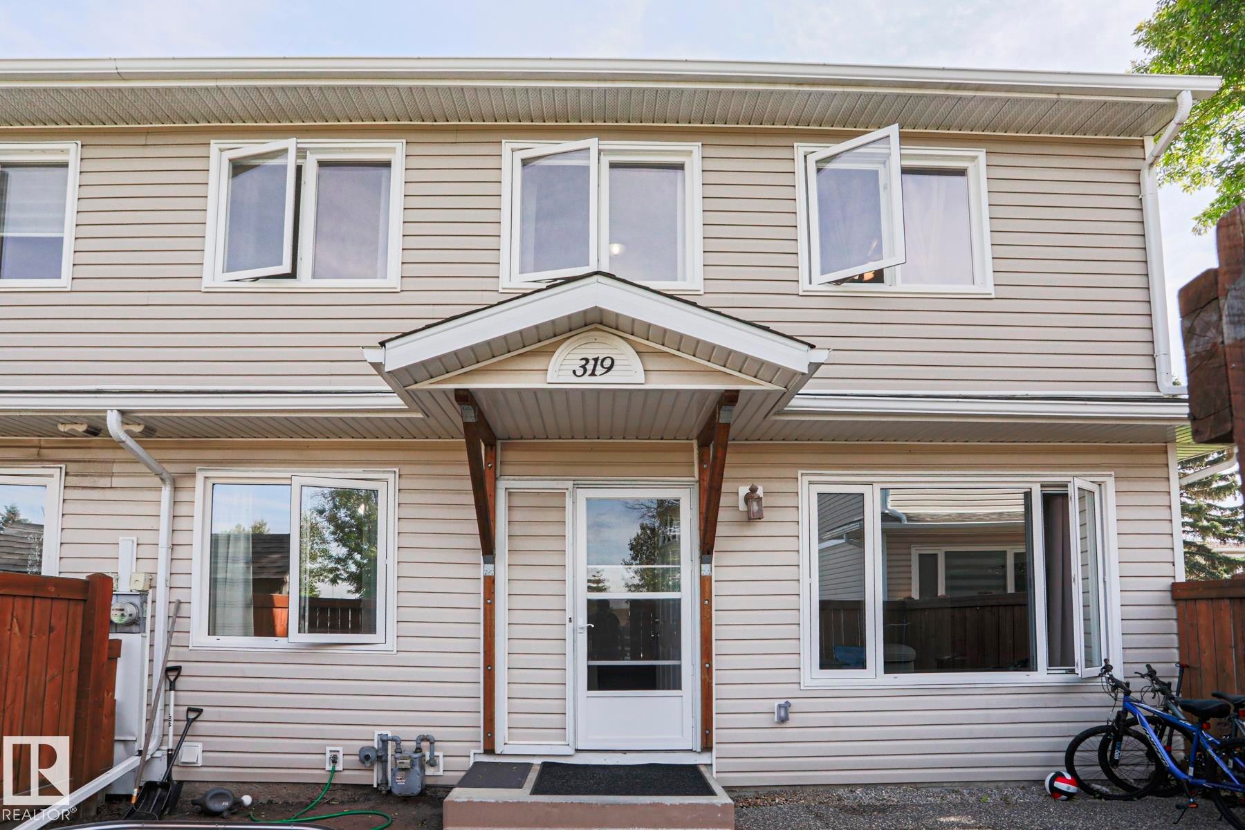 Vinyl siding exterior with white trim - 319 Telford Court, Leduc, AB