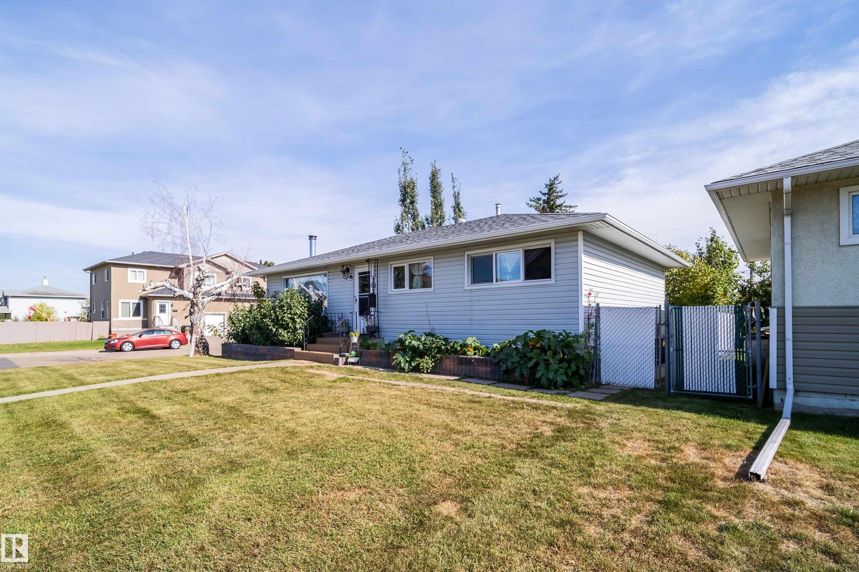 Single-story residence featuring light gray siding and a dark shingle roof - 10245 160 Street Nw, Edmonton, AB