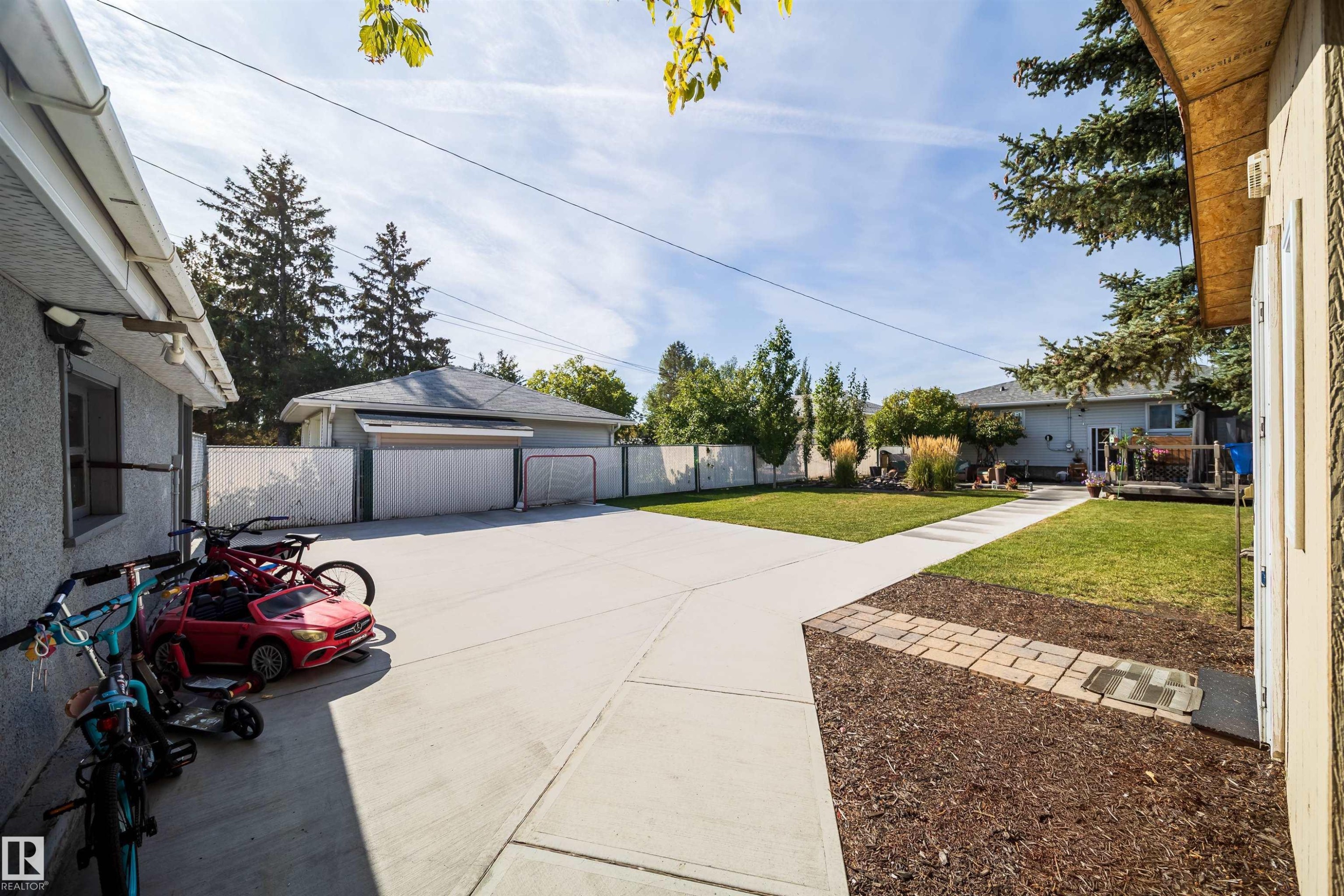 Expansive concrete patio and pathways with a detached garage - 10245 160 Street Nw, Edmonton, AB