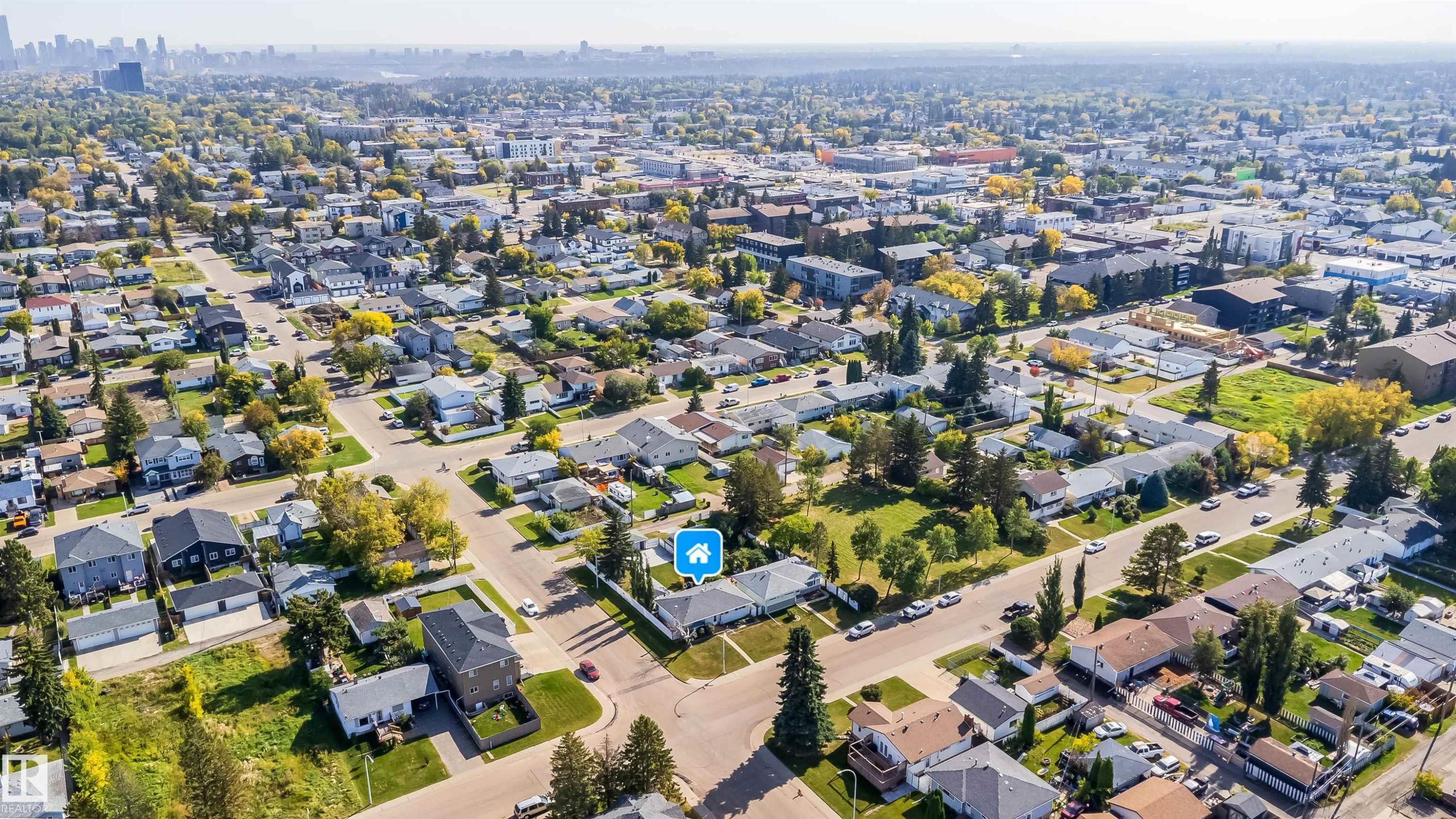 Residential neighborhood with a mix of single-family homes and multi-story buildings, featuring tree-lined streets and varied architectural styles - 10245 160 Street Nw, Edmonton, AB