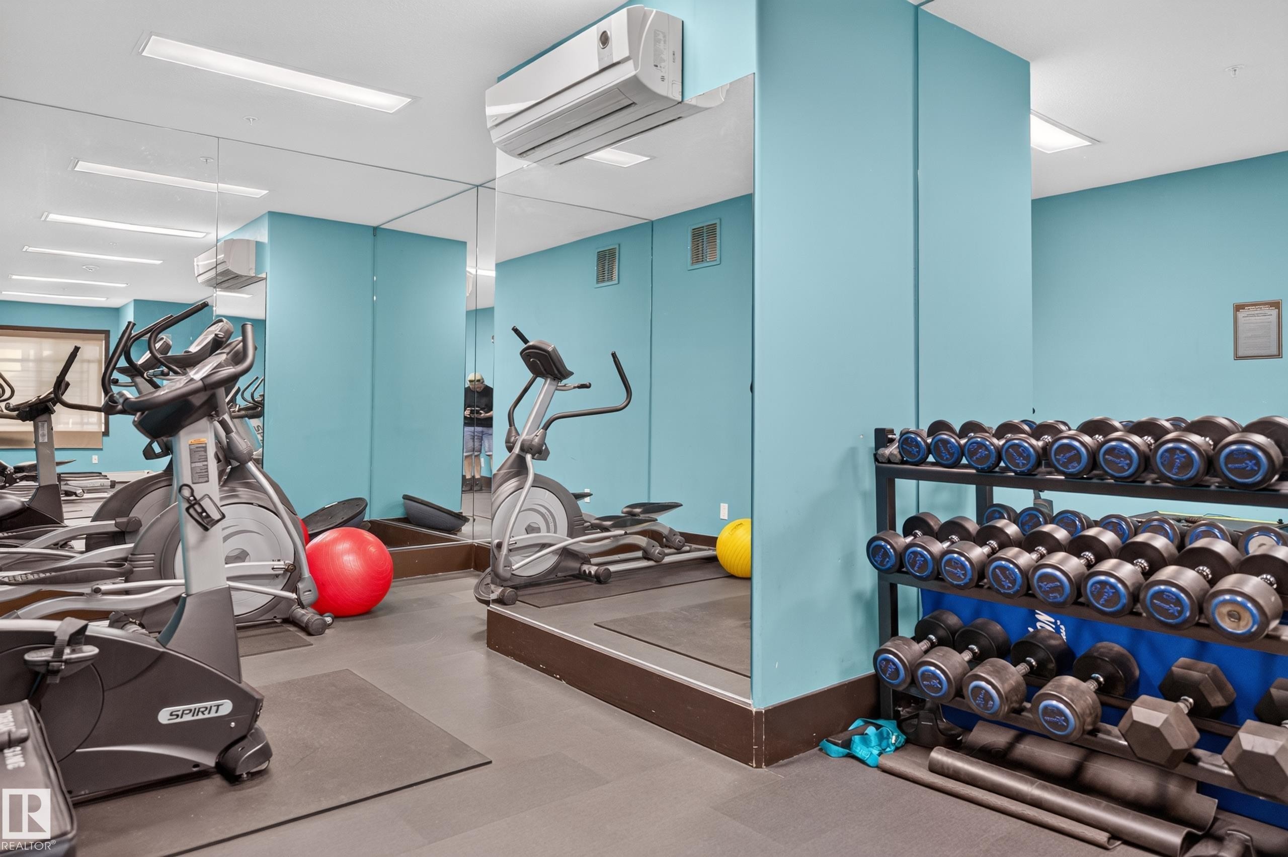 Dedicated fitness area featuring exercise equipment, full-height wall mirrors, overhead lighting, and built-in climate control - #411 304 Ambleside Link Li Sw, Edmonton, AB