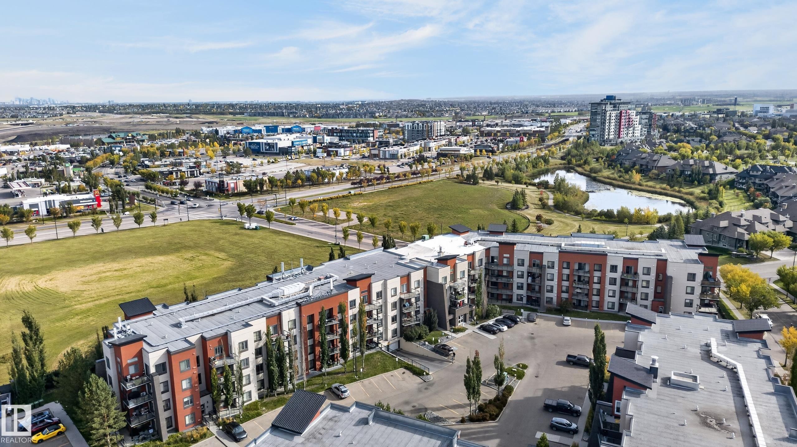 Multi-story residential building with private balconies and surface parking - #411 304 Ambleside Link Li Sw, Edmonton, AB