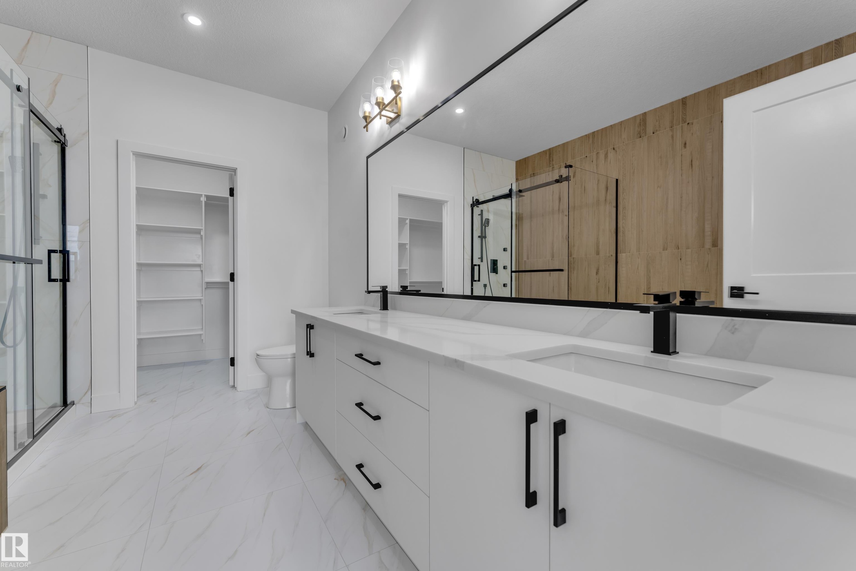 Dual vanity with integrated sinks, white cabinetry, quartz countertops, and matte black fixtures - 4212 63 Street, Beaumont, AB