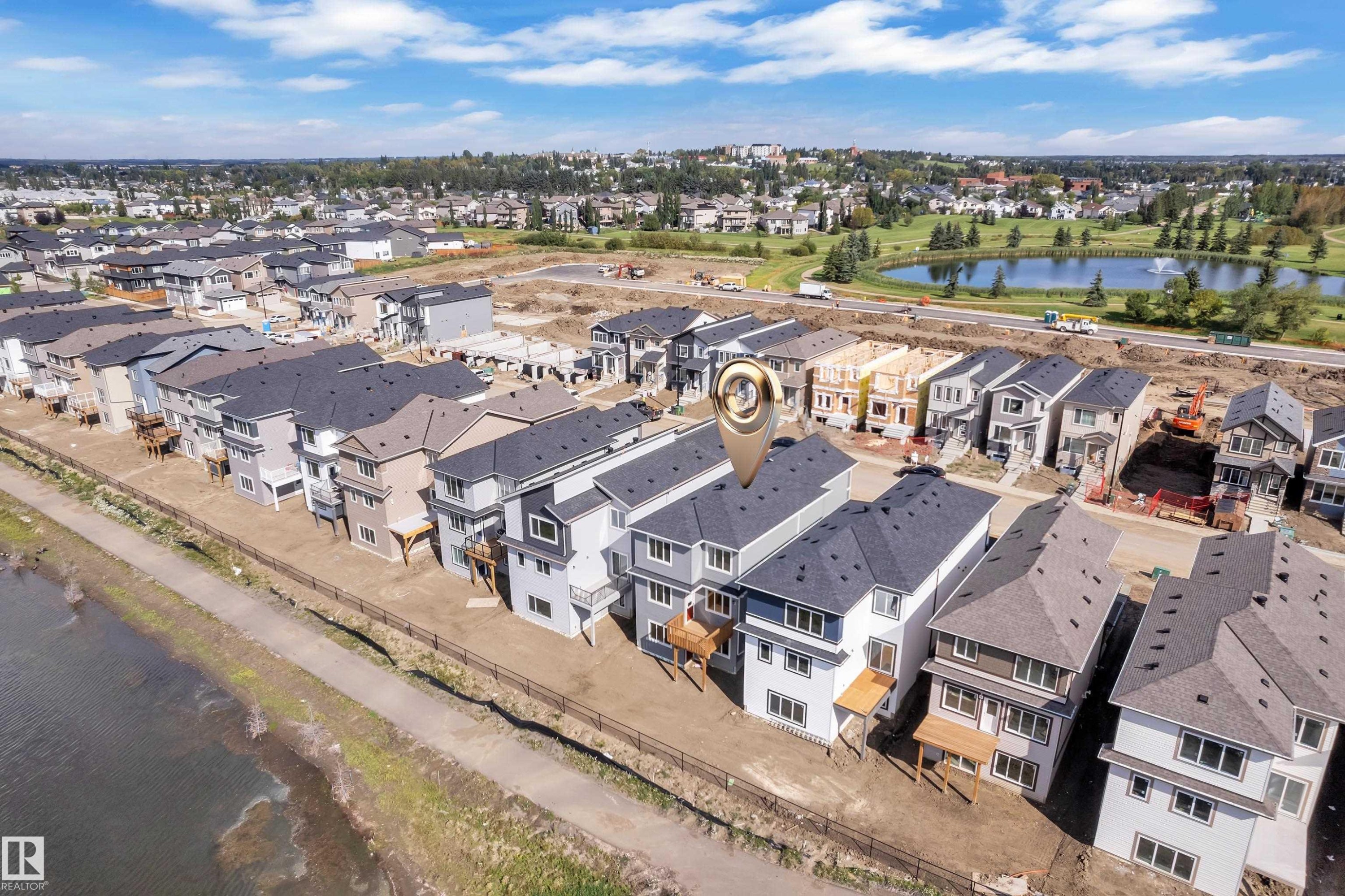 Modern multi-story residences with dark shingled roofs and light-toned siding - 4212 63 Street, Beaumont, AB
