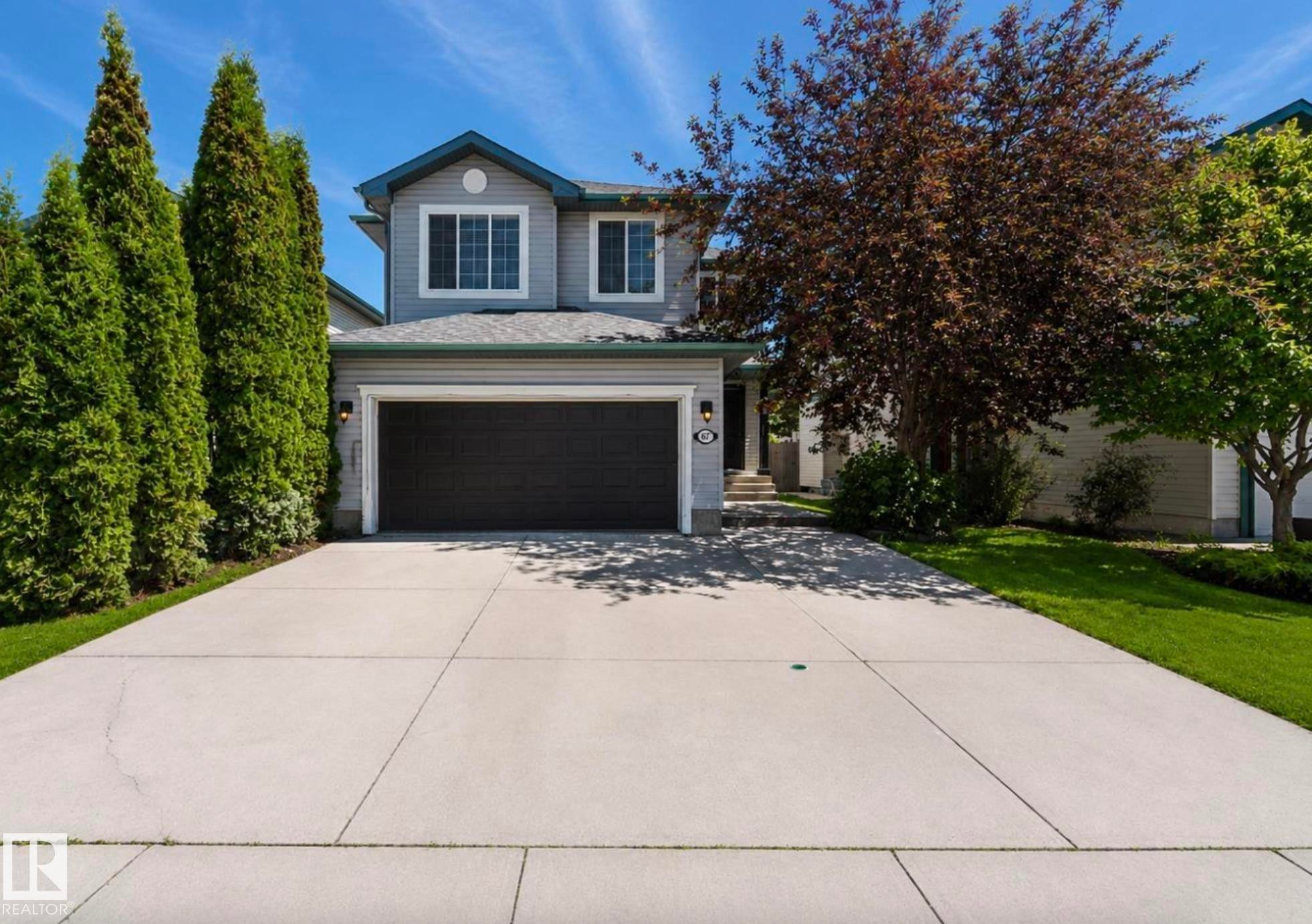 Two-story residence featuring light gray siding with blue trim accents - 1007 Macewan Close Sw, Edmonton, AB - Outdoor With Facade